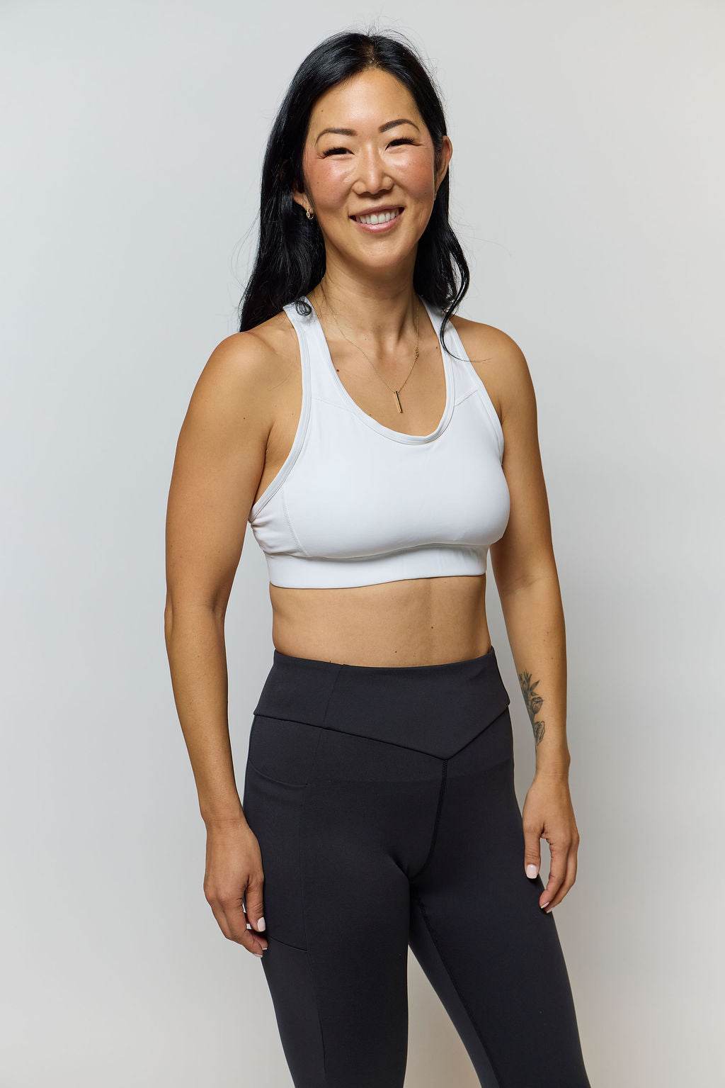 99'er Padded Sports Bra in white with a smooth, stretchy finish, scoop neckline and wide shoulder straps