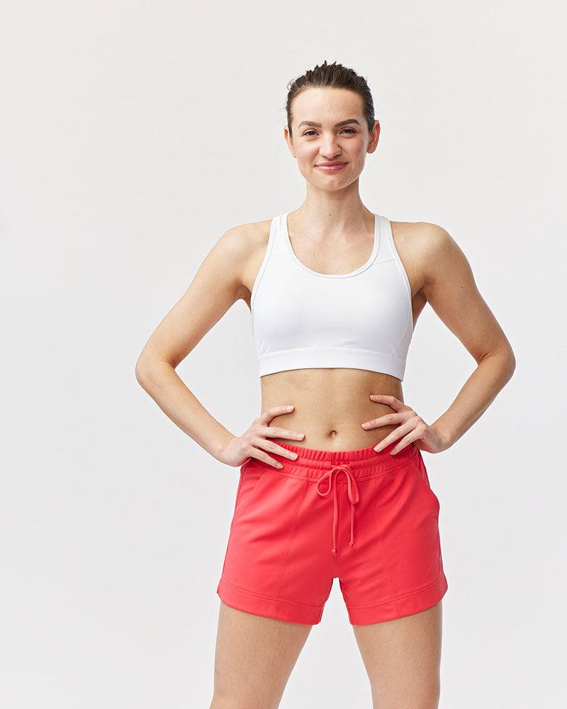 99'er Padded Sports Bra in white stretch fabric, featuring a scoop neckline, wide straps and a fitted cropped shape