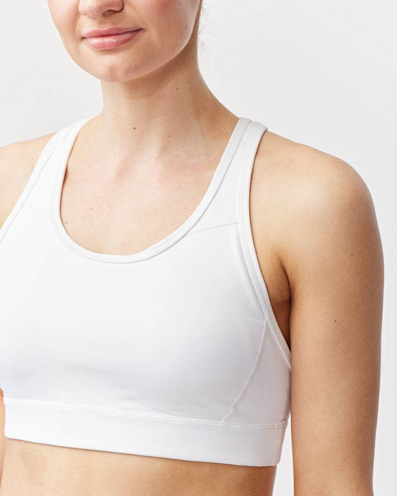 99'er Padded Sports Bra in white stretch fabric with a scoop neckline, wide shoulder straps and a supportive band
