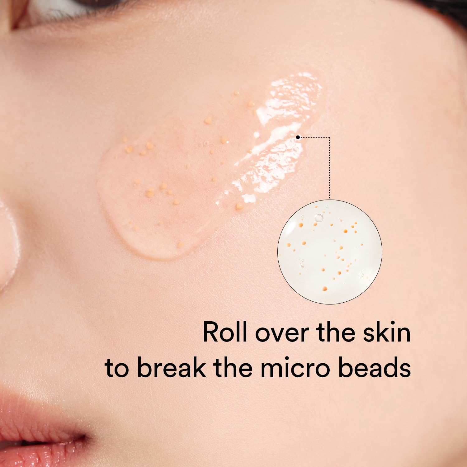 Abib Glutathiosome Dark Spot Serum gel with visible orange micro beads applied on cheek skin demonstrating use