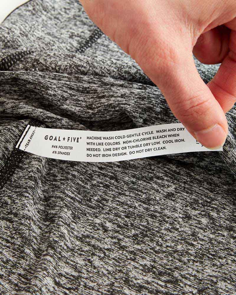 Advance Women's Training Top in grey and black heathered fabric with a sewn-in care label and soft knit texture