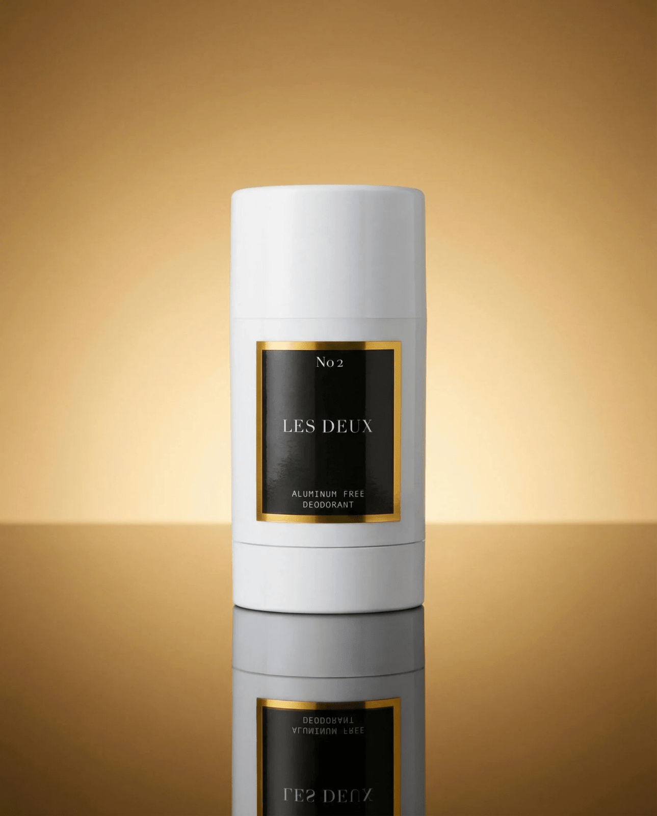 White cylindrical deodorant stick with a black and gold label reading No. 2 LES DEUX, aluminum free deodorant.