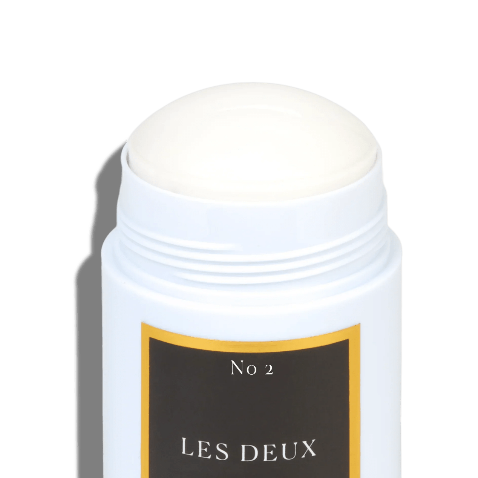 No. 2 Peau d’Or aluminum free deodorant in white container with black and gold label, smooth solid stick visible on top.