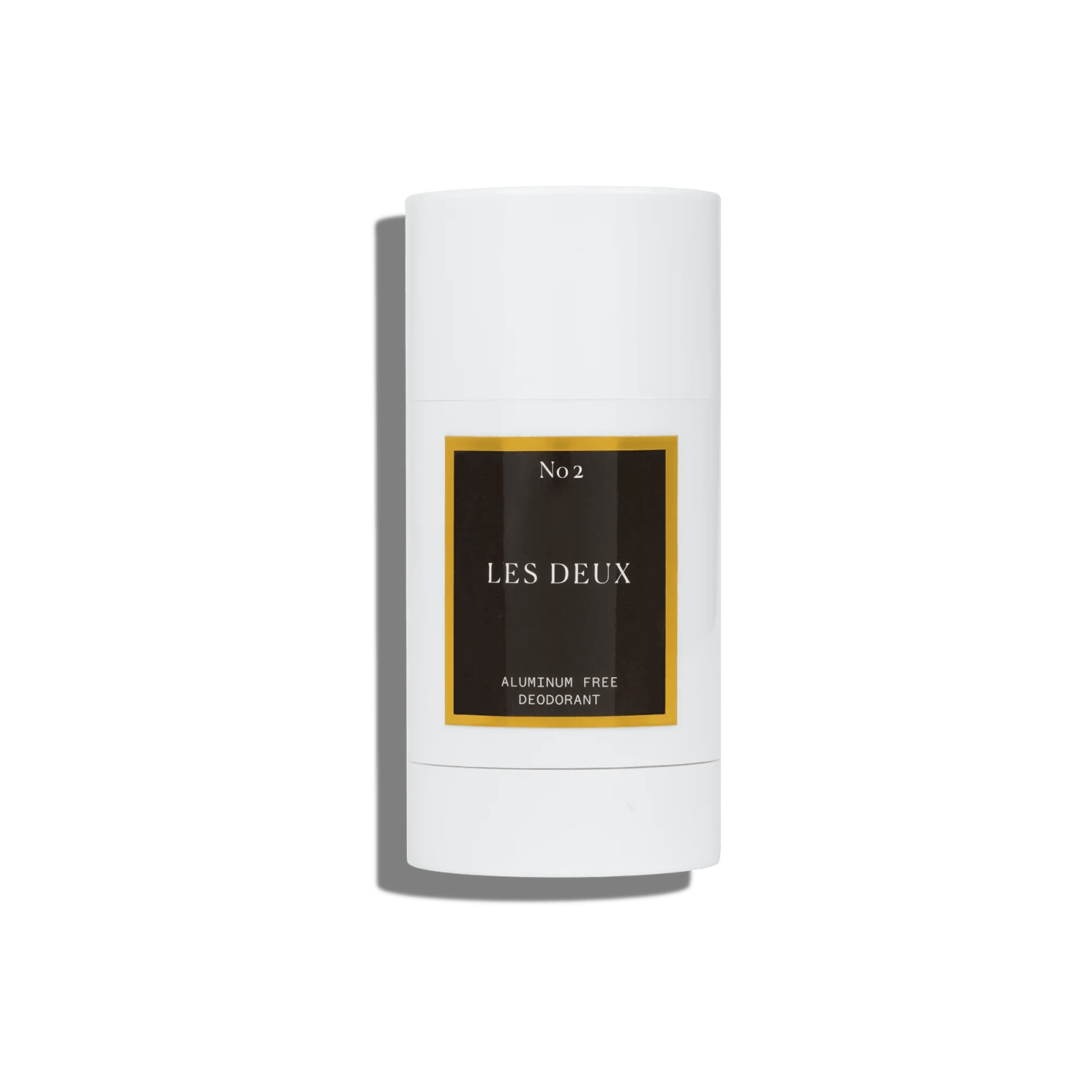 White plastic deodorant stick with a black and gold label reading "No 2 LES DEUX," aluminum free deodorant.