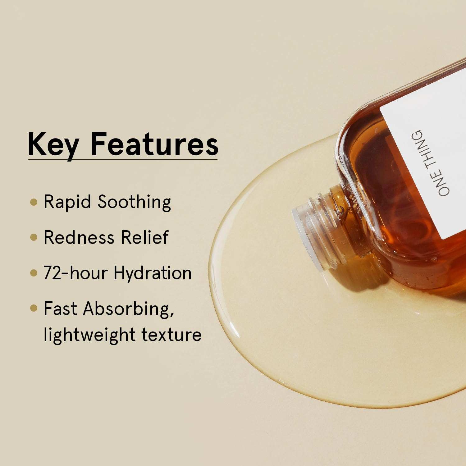 Asiatica Extract Toner in a clear amber plastic bottle with a white label showing the brand ONE THING and spilled liquid on a beige surface