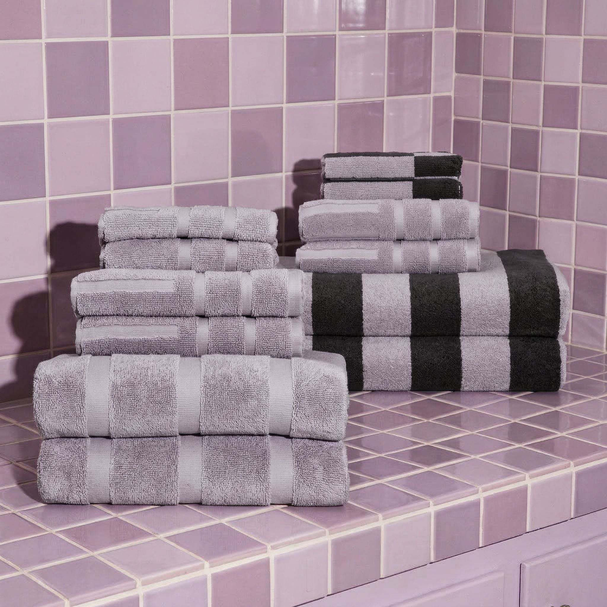Australian Cotton towels in lilac and black striped plush cotton with a dense soft texture arranged on pastel purple tiled surface