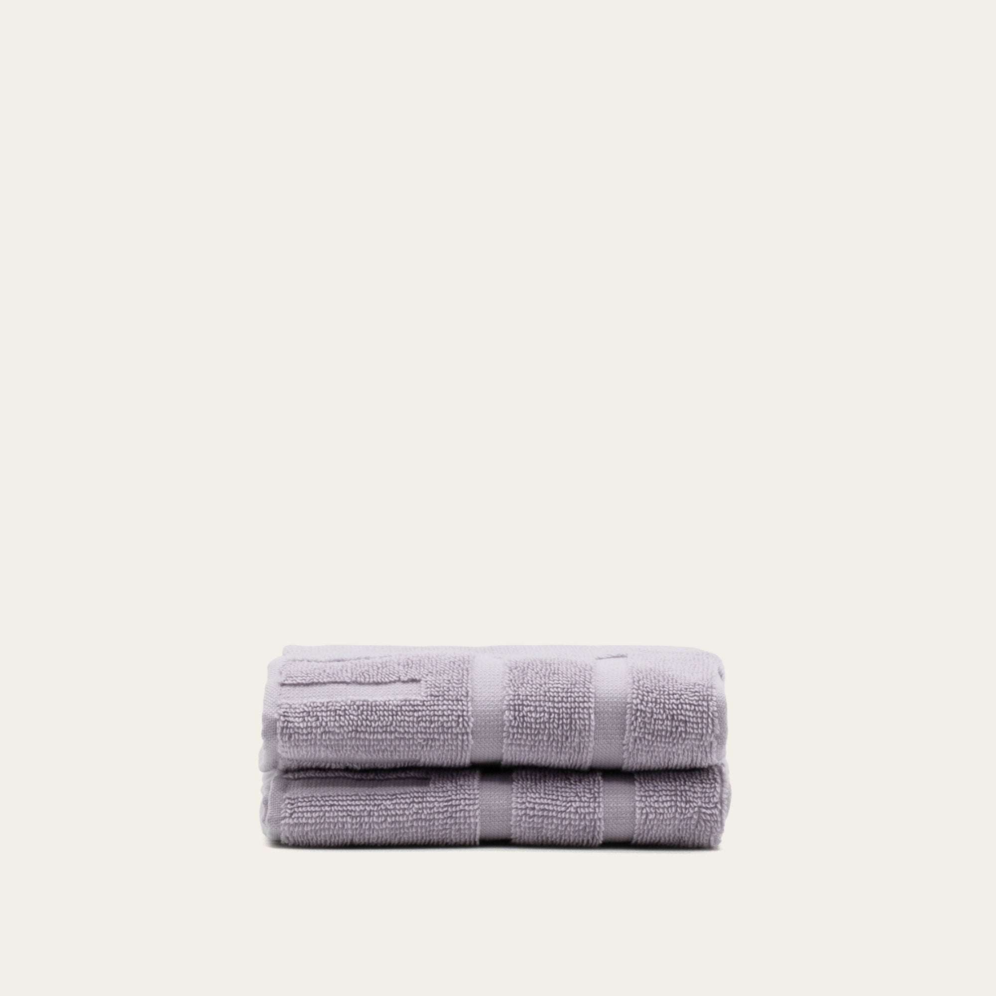 Australian Cotton towels in soft lilac color with subtle geometric patterns, dense and plush 600 GSM cotton fabric.