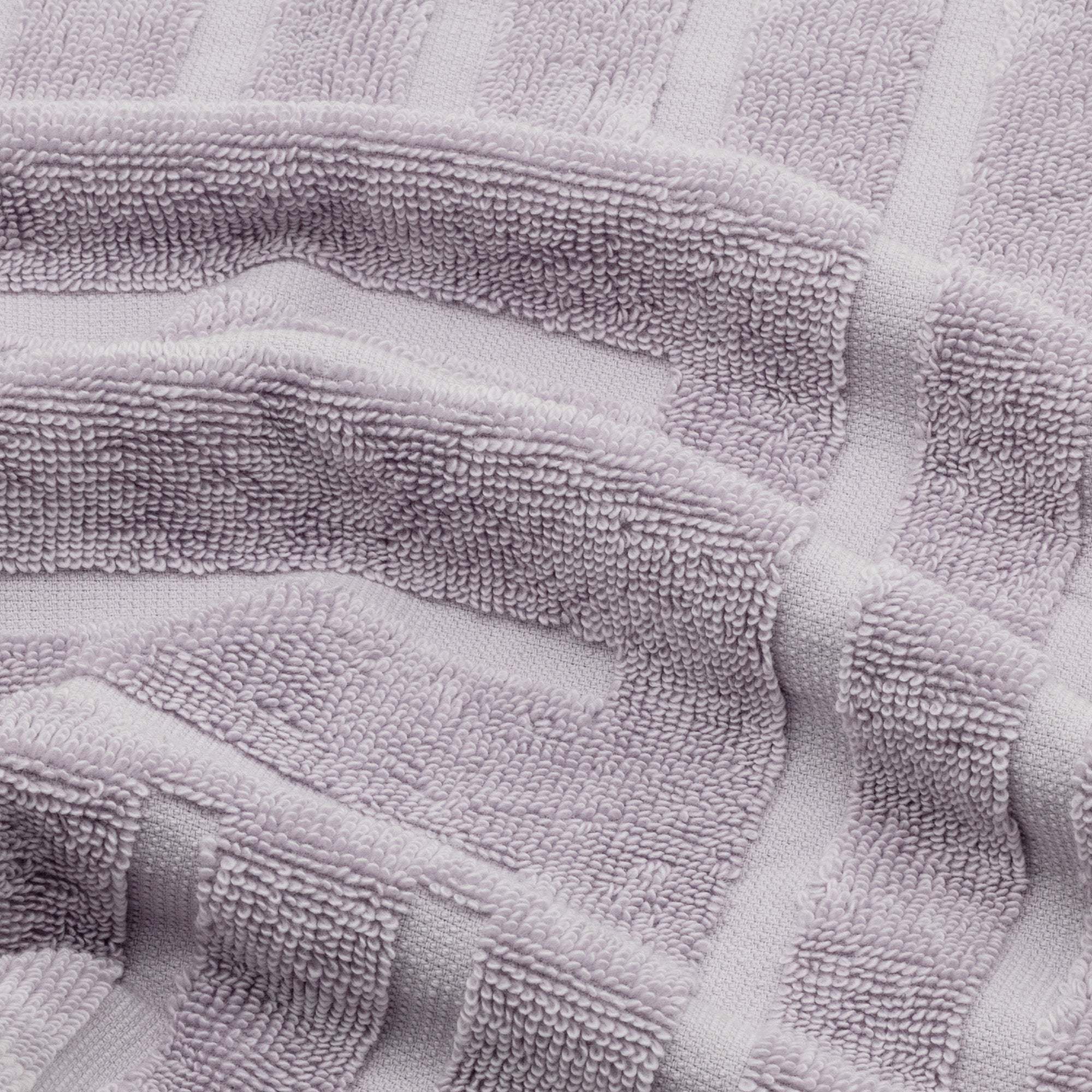 Lilac Australian Cotton towels featuring a geometric pattern with soft, dense 600 GSM cotton texture