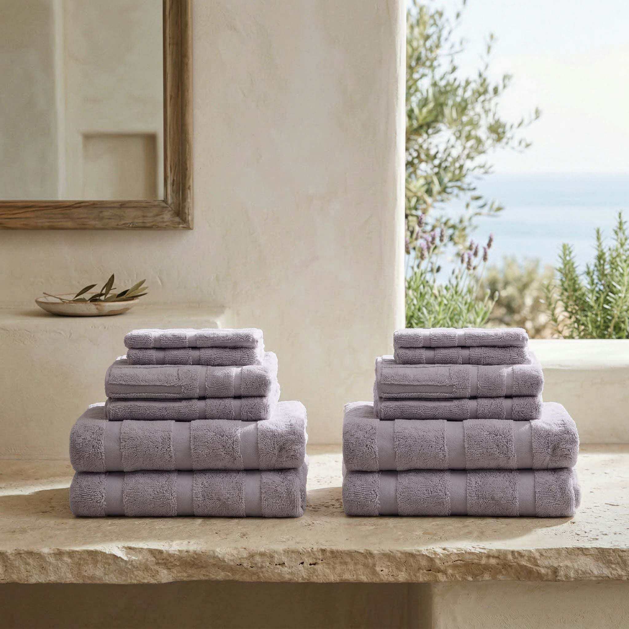 Australian Cotton towels in soft lilac color with geometric patterns, dense and plush texture stacked in two sets