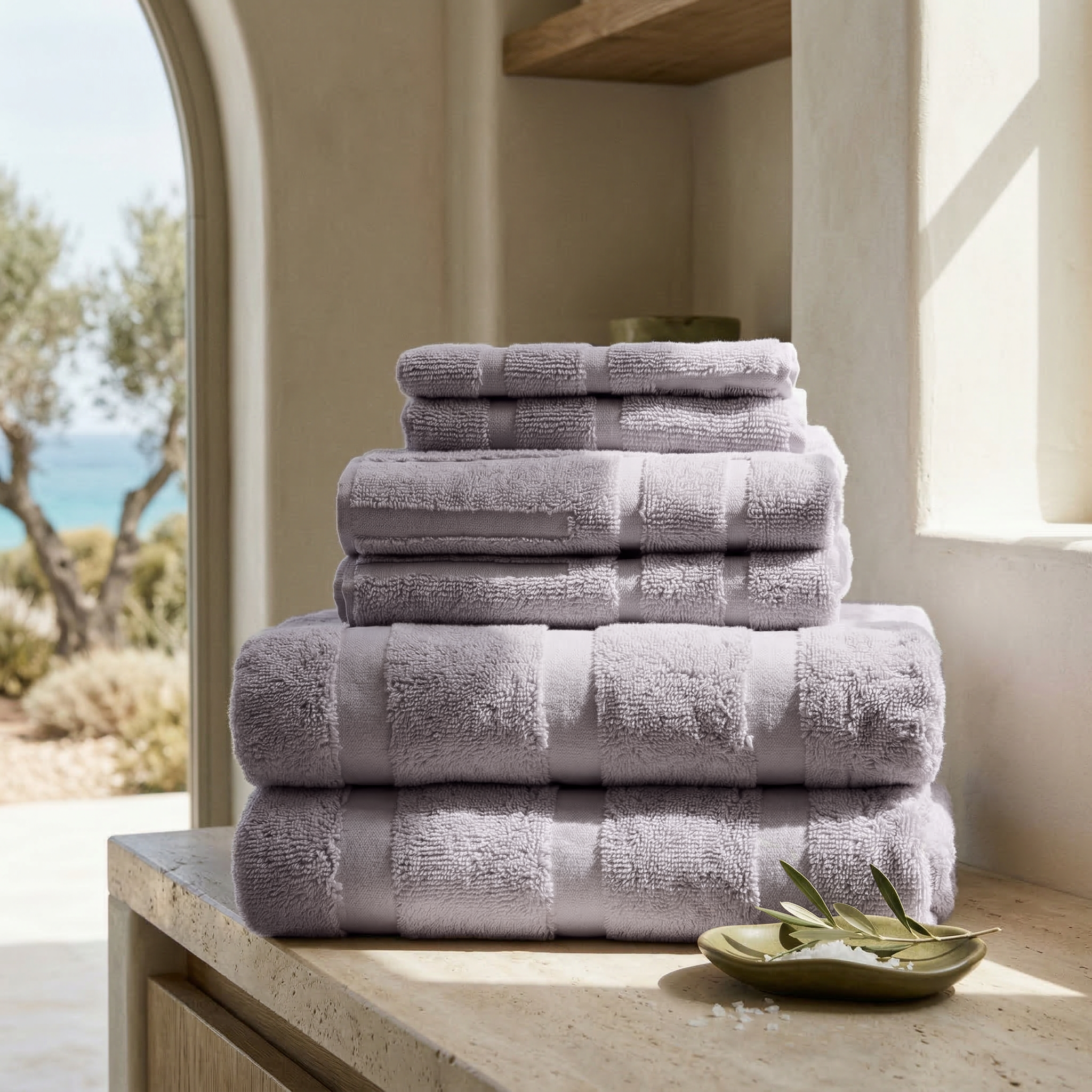 Set of lilac Australian Cotton towels stacked neatly, featuring a plush texture and subtle geometric pattern