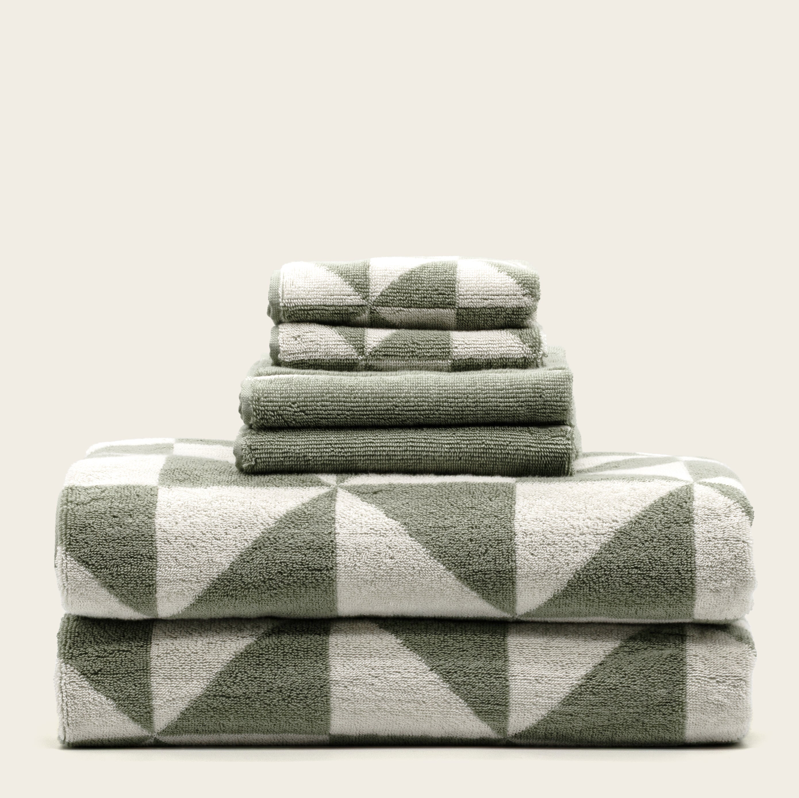 Australian Cotton Towels in sage green and cream with a plush terry texture and bold geometric triangle pattern
