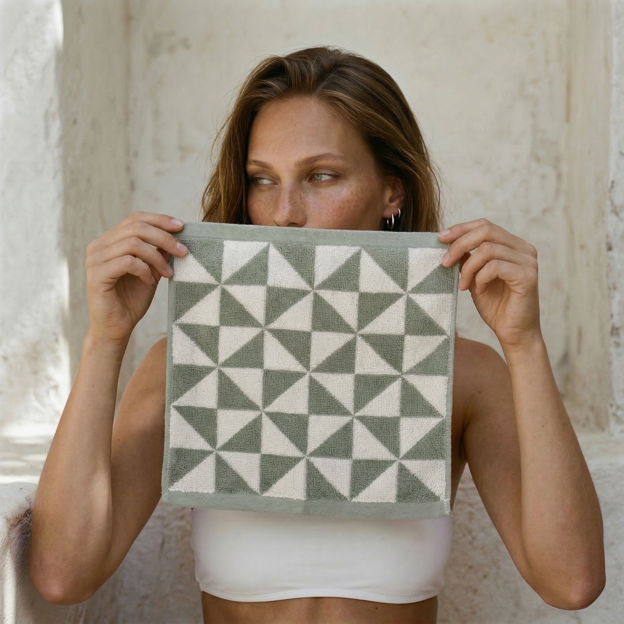 Australian Cotton Towels washcloth in sage green and cream cotton, featuring a bold geometric triangle pattern