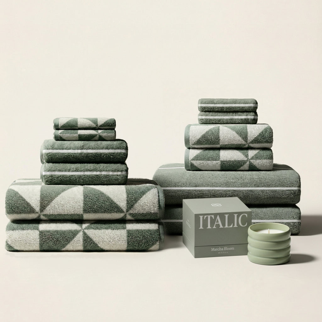 Australian Cotton Towels in sage green and cream, with plush cotton fabric and bold triangular geometric patterns.