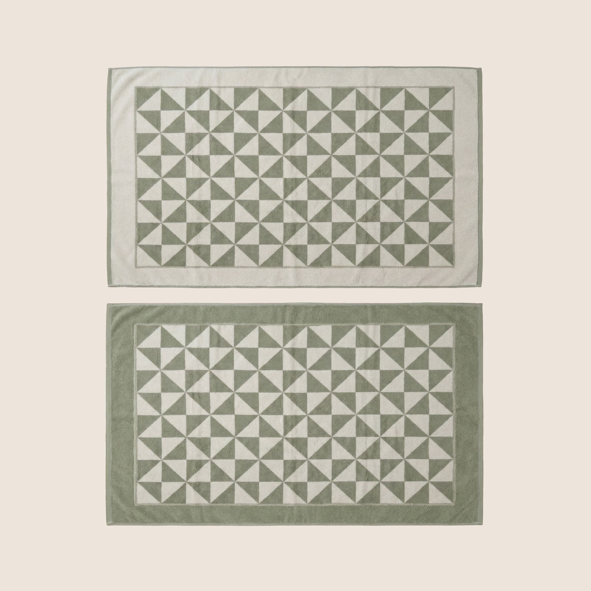 Australian Cotton Towels in sage green and ivory cotton, featuring a repeating geometric triangle pattern and bordered edges