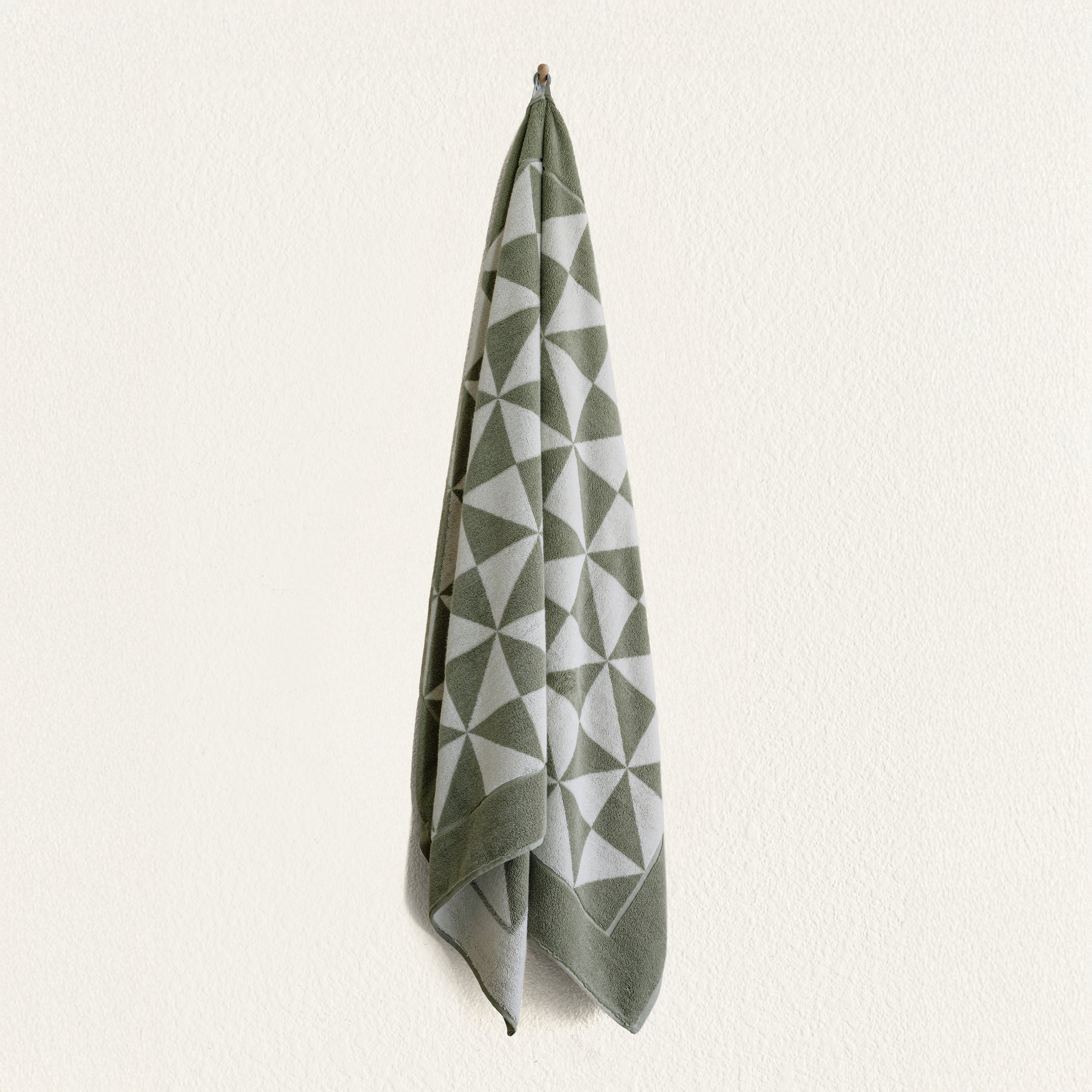 Australian Cotton Towels in sage green and white with a plush texture and repeating geometric triangle pattern