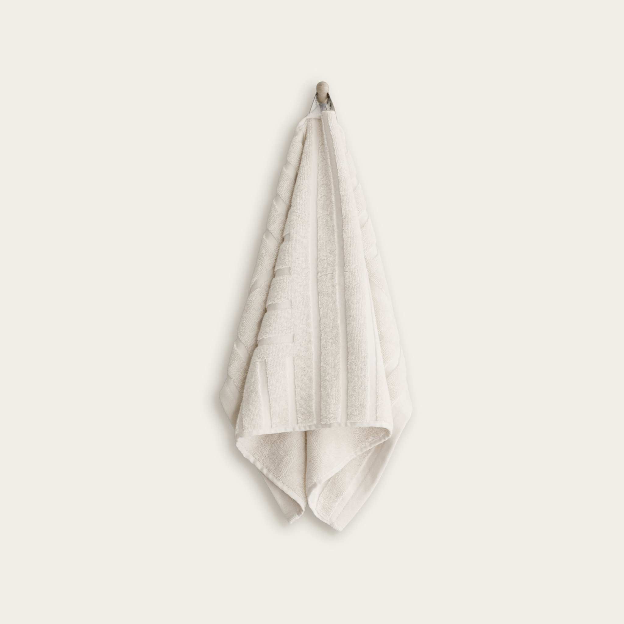 Australian Cotton towels in soft ecru color with a subtle geometric pattern and functional locker loop hanging