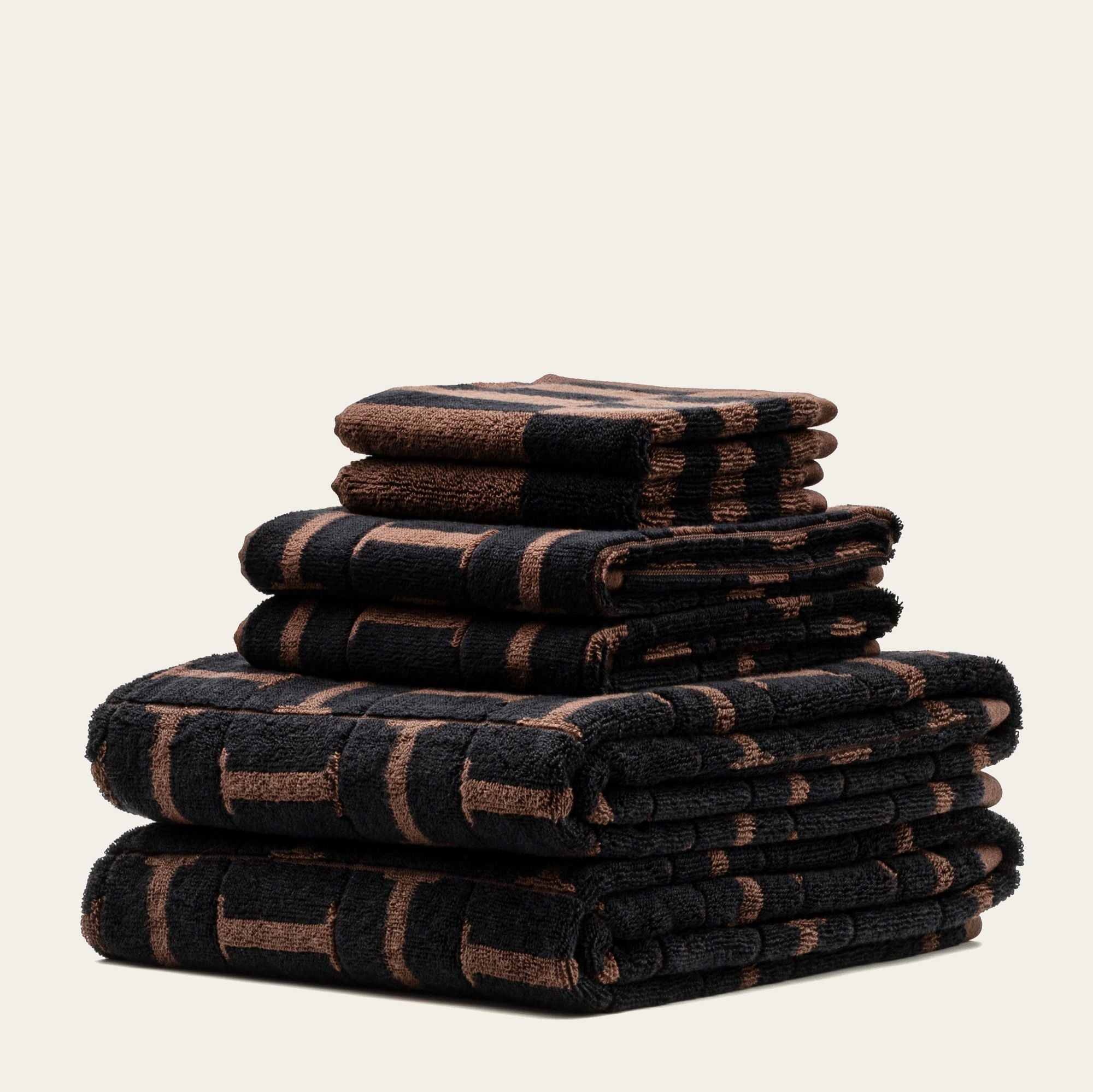 Tessera Australian cotton towels in moody coastal tones with geometric pattern