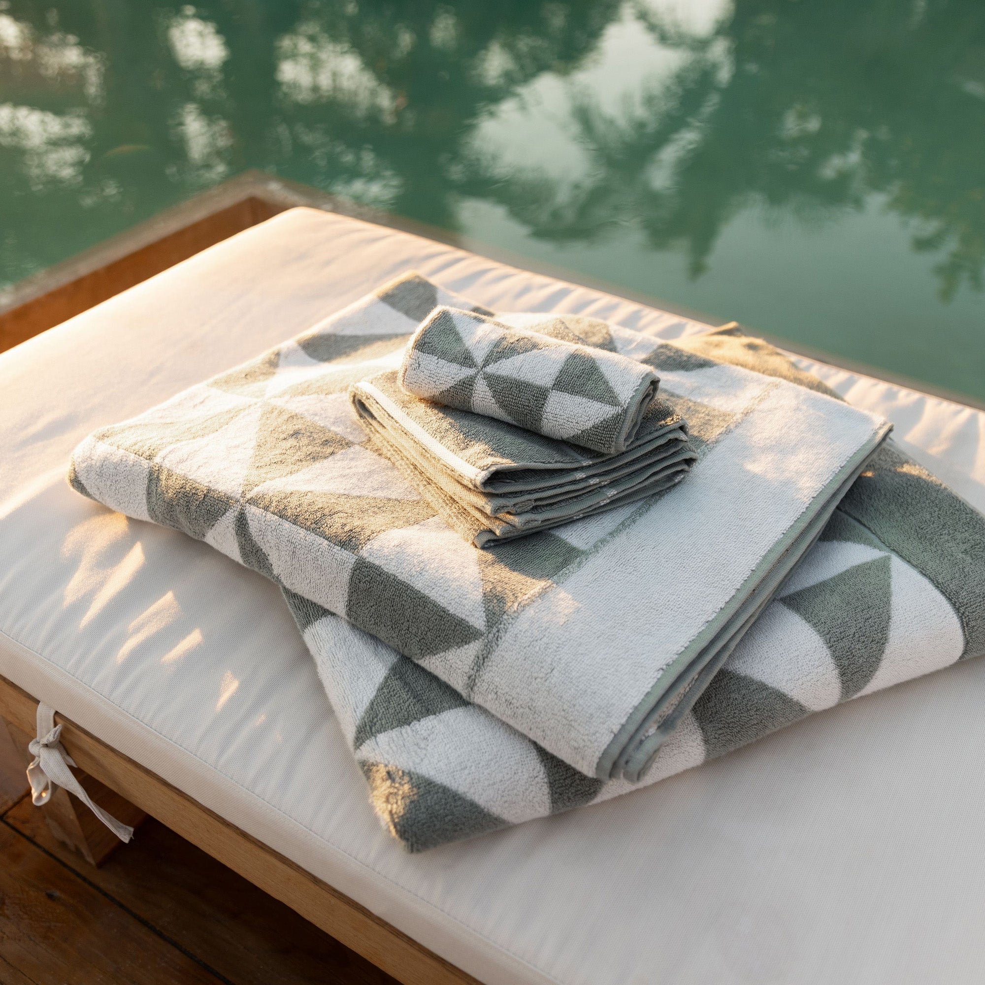 Australian Cotton Towels in soft white and grey cotton, featuring a plush texture and bold triangular geometric pattern
