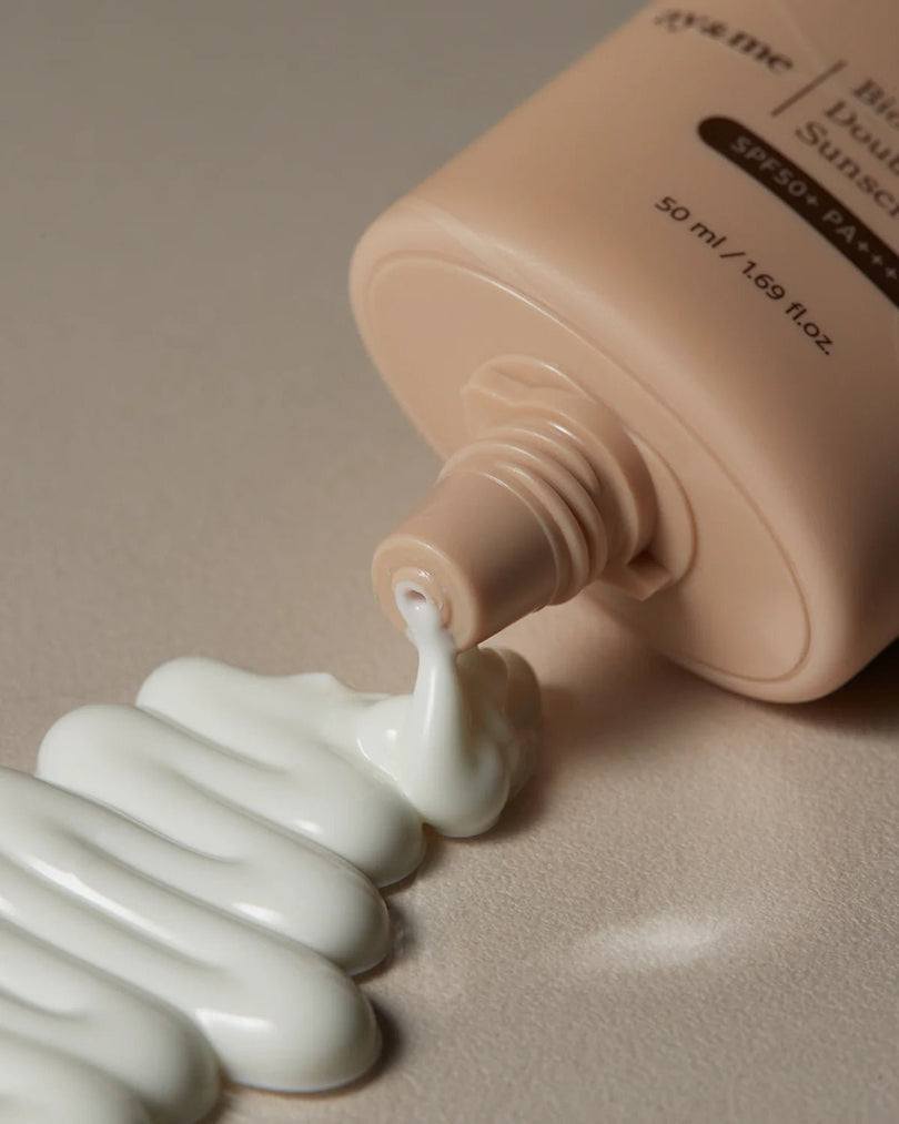 AXIS-Y Biome Double Defense Sunscreen in beige tube with white creamy sunscreen lotion spilled out