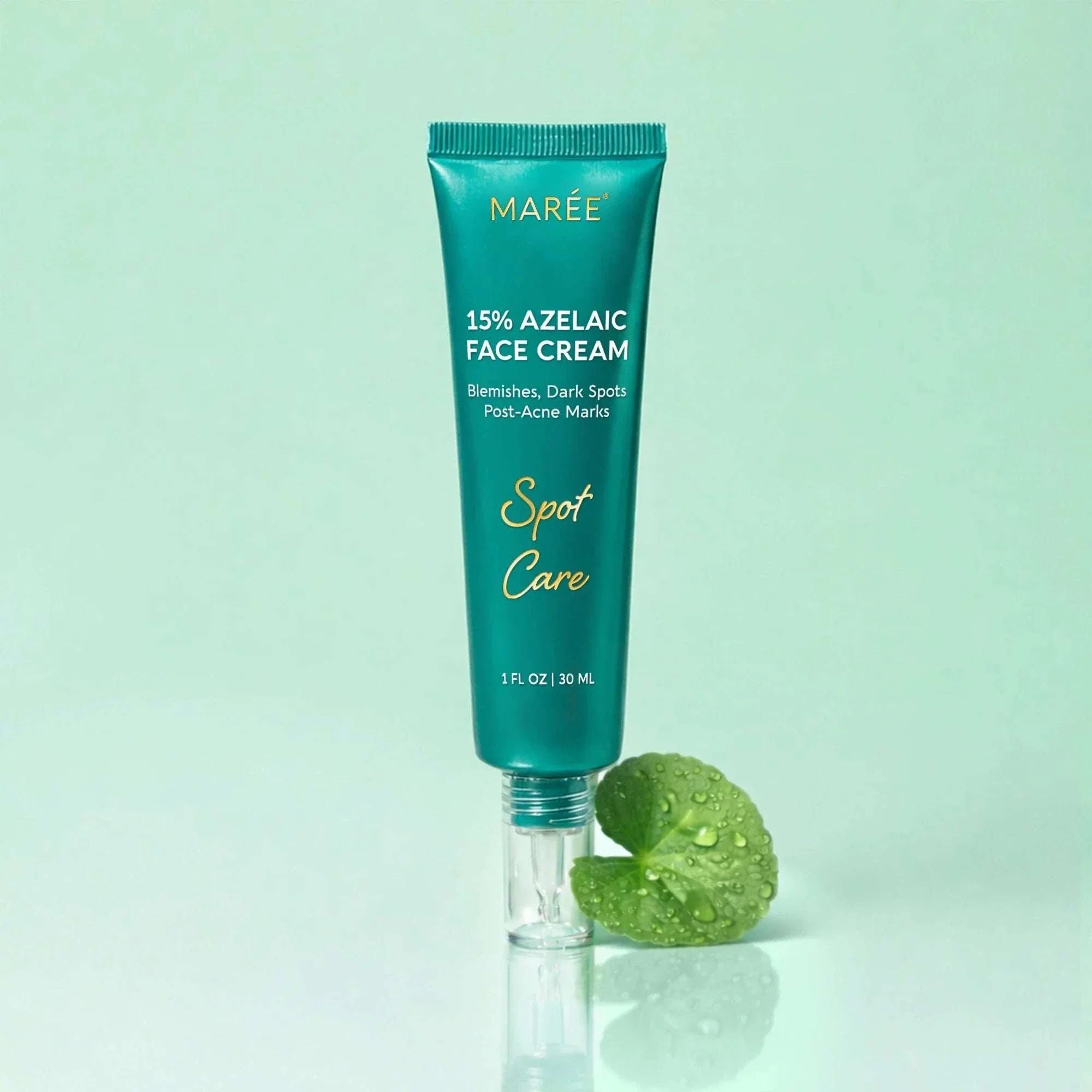 Azelaic Acid Cream in a teal tube with gold lettering and a clear base, paired with a green leaf.