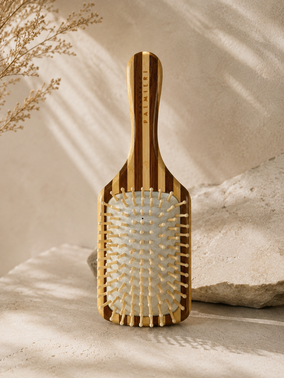 Bamboo Hairbrush in natural striped wood with pale rounded bristles and a long handle marked Palmieri