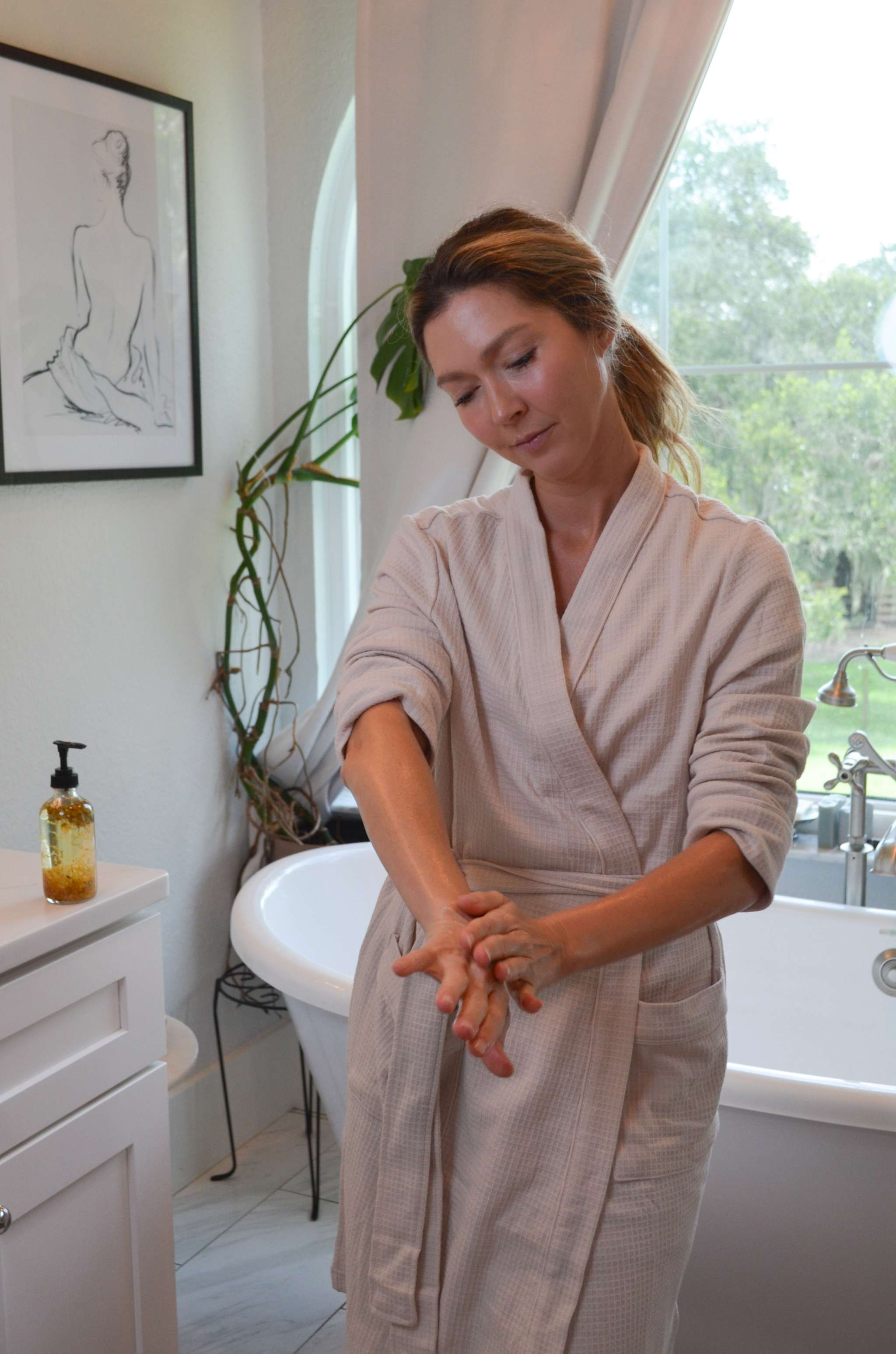 Bare Flower Fragrance-Free Body Oil in a clear pump bottle with golden botanical oil for moisturized skin