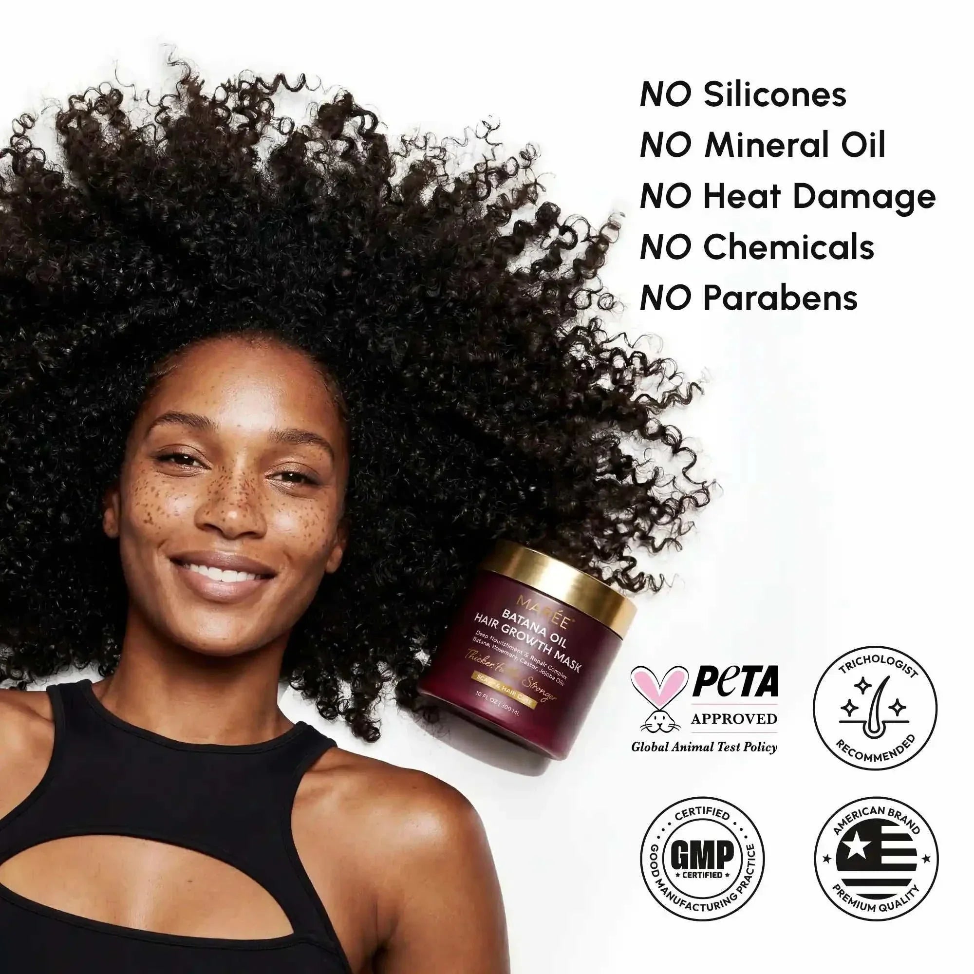 Batana Hair Growth Mask in a burgundy jar with a gold lid beside a smiling woman with voluminous natural curls