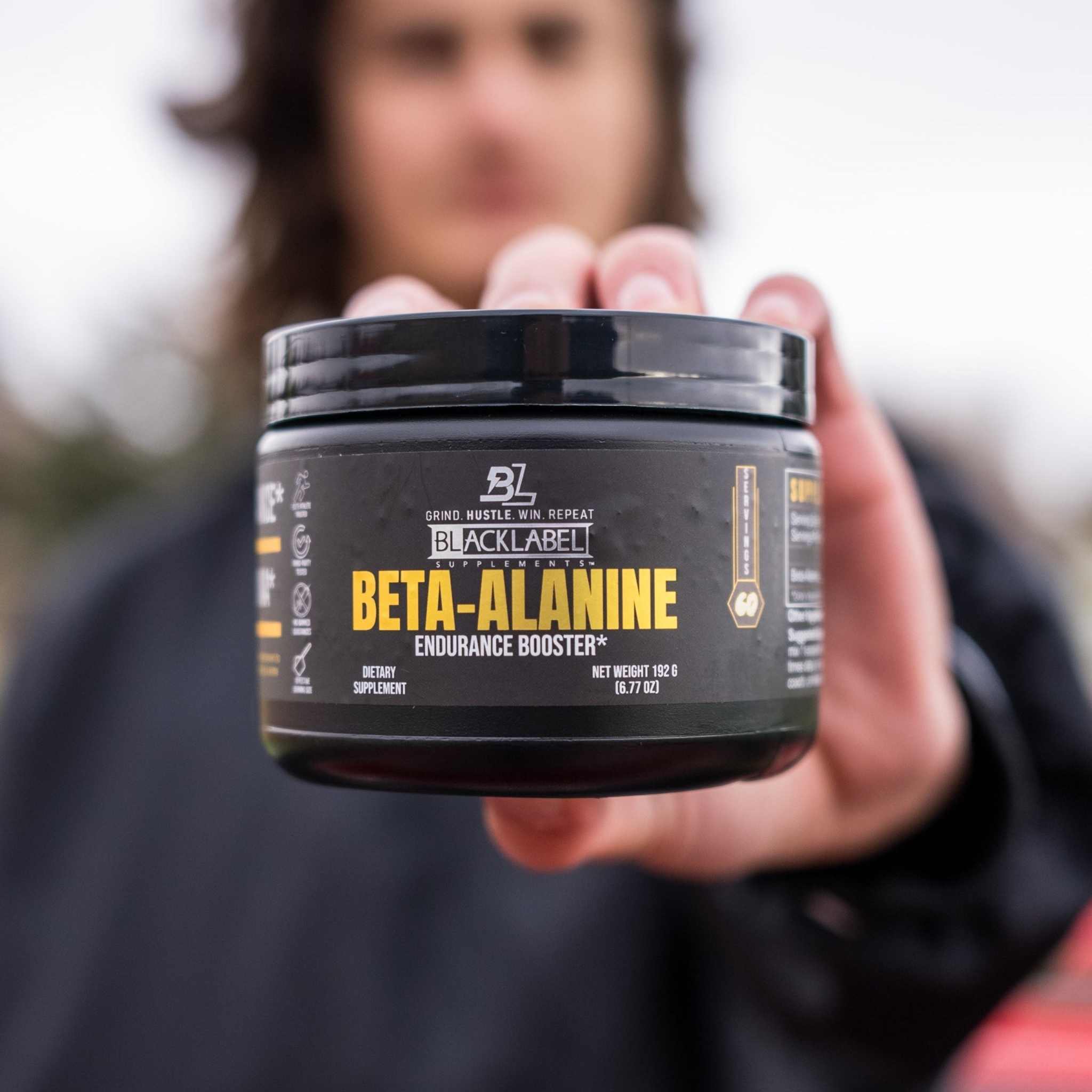 BETA-ALANINE endurance booster in a black plastic supplement tub with a dark label and bold yellow lettering
