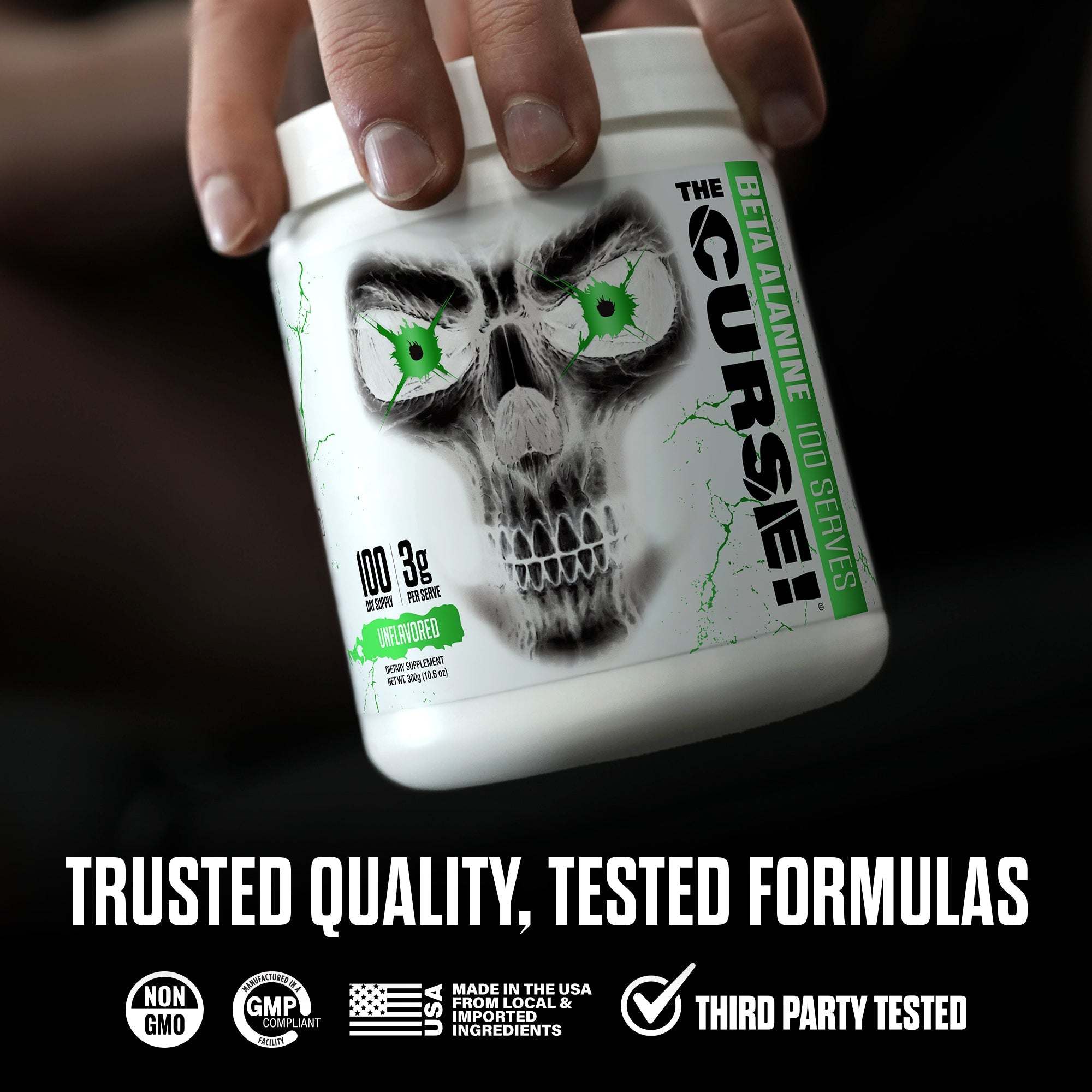 White container of The Curse! Beta Alanine supplement with black skull and green eyes design held by hand, highlighting 3g Beta Alanine per scoop