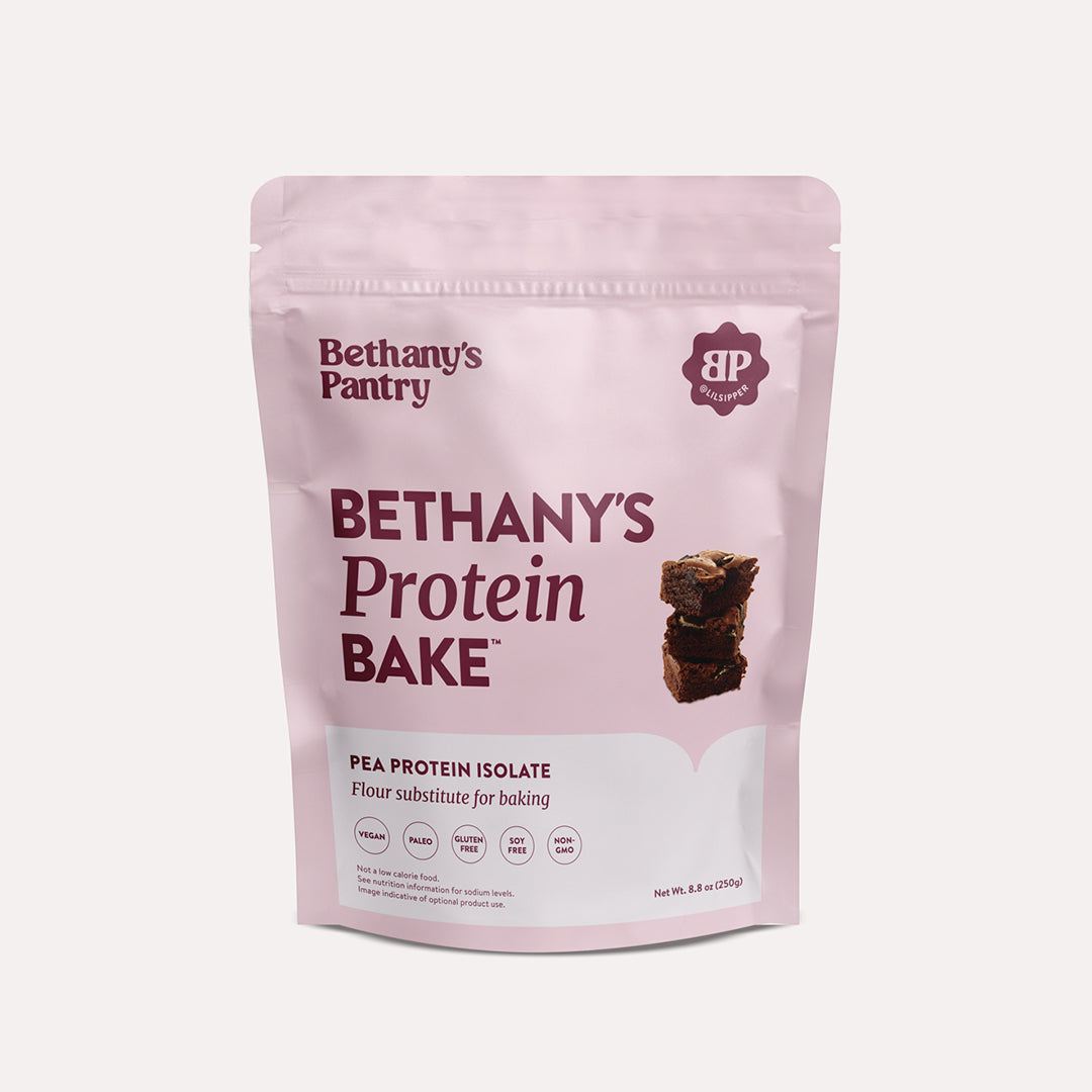 Bethany's Protein Bake pea protein powder in a pale pink resealable pouch with burgundy lettering and brownie image