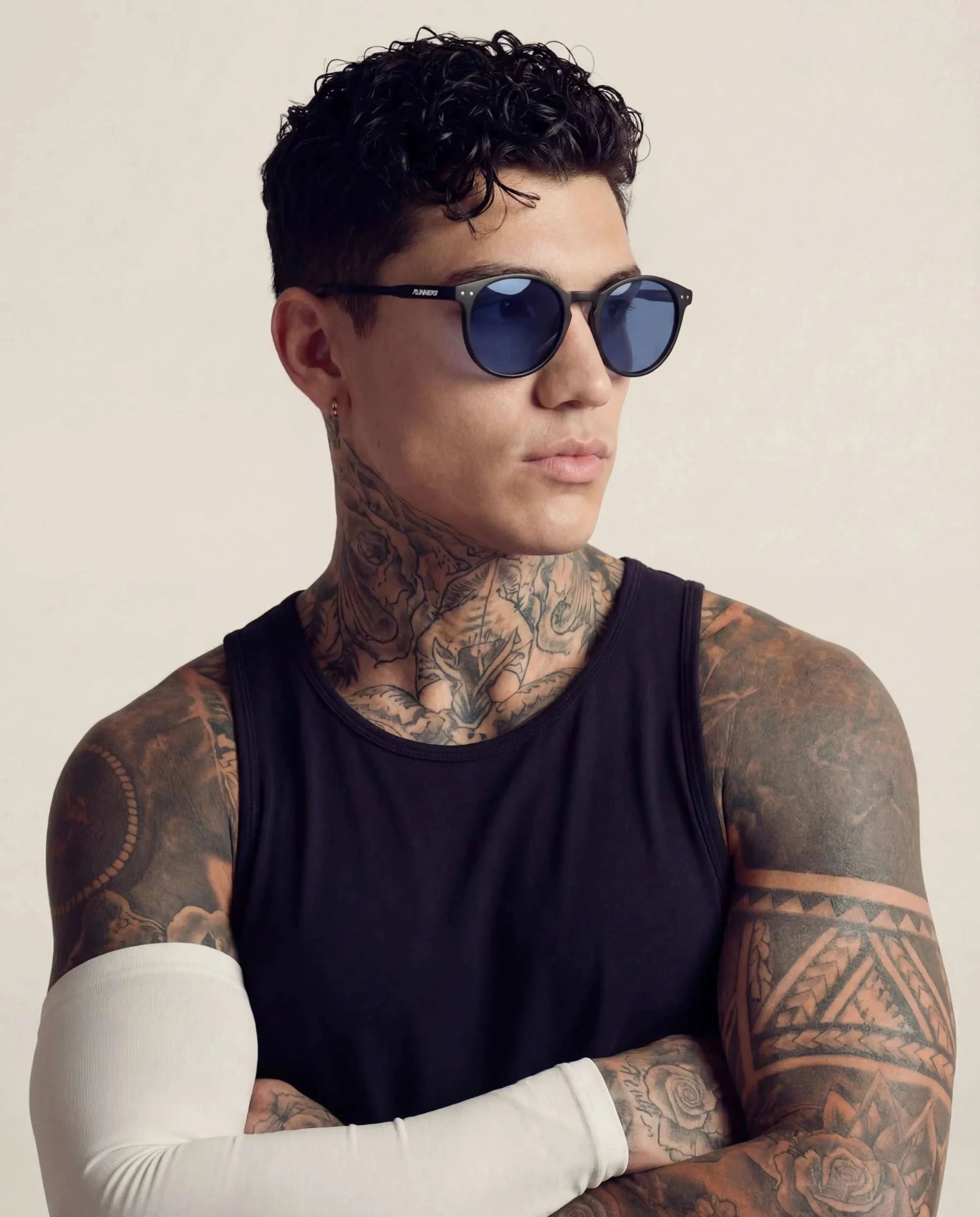 Black Round Polarized Sunglasses with dark blue round lenses and slim black frames, worn by a model