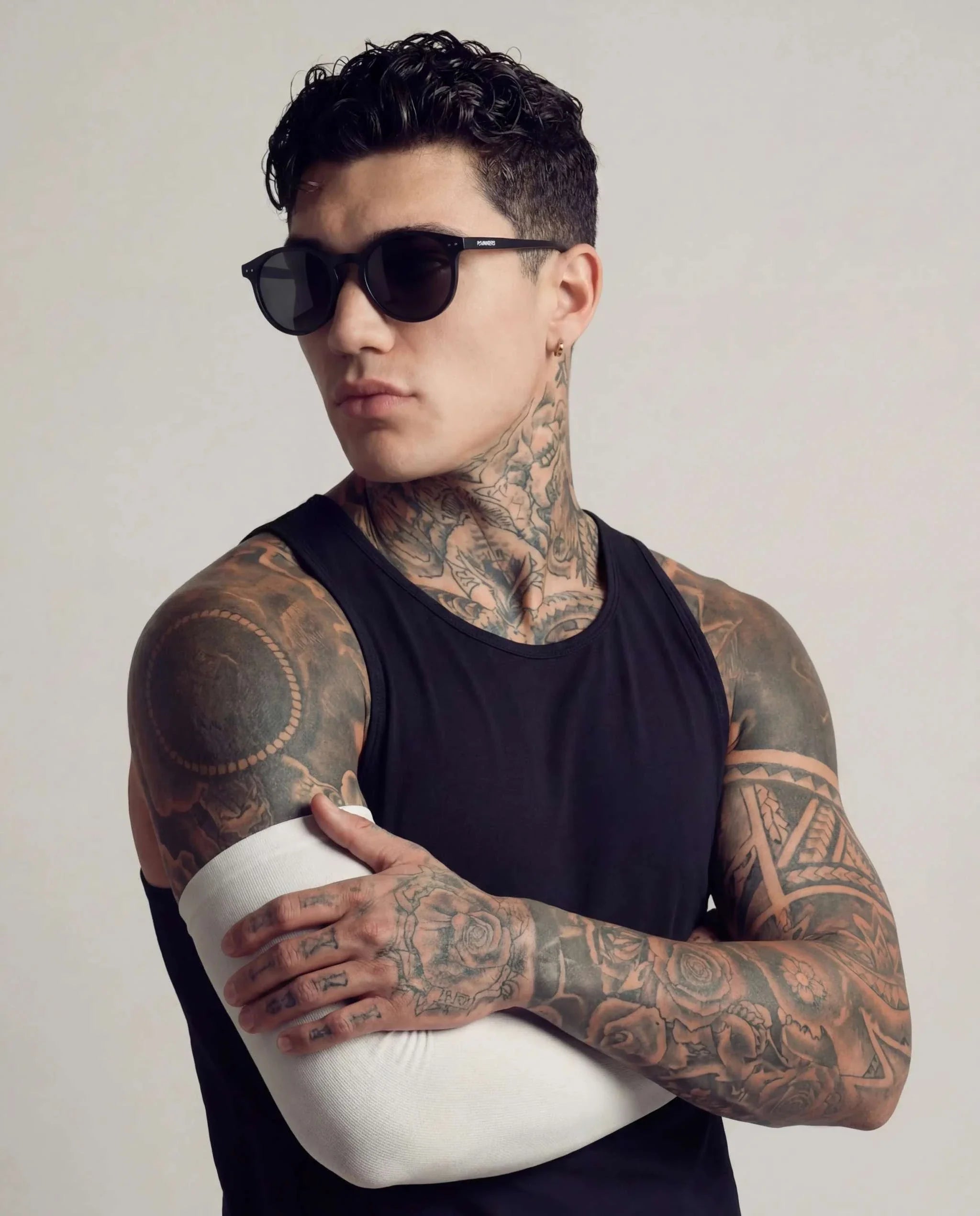 Black Round Polarized Sunglasses with dark lenses and a slim black frame, worn by a man with short curly hair.