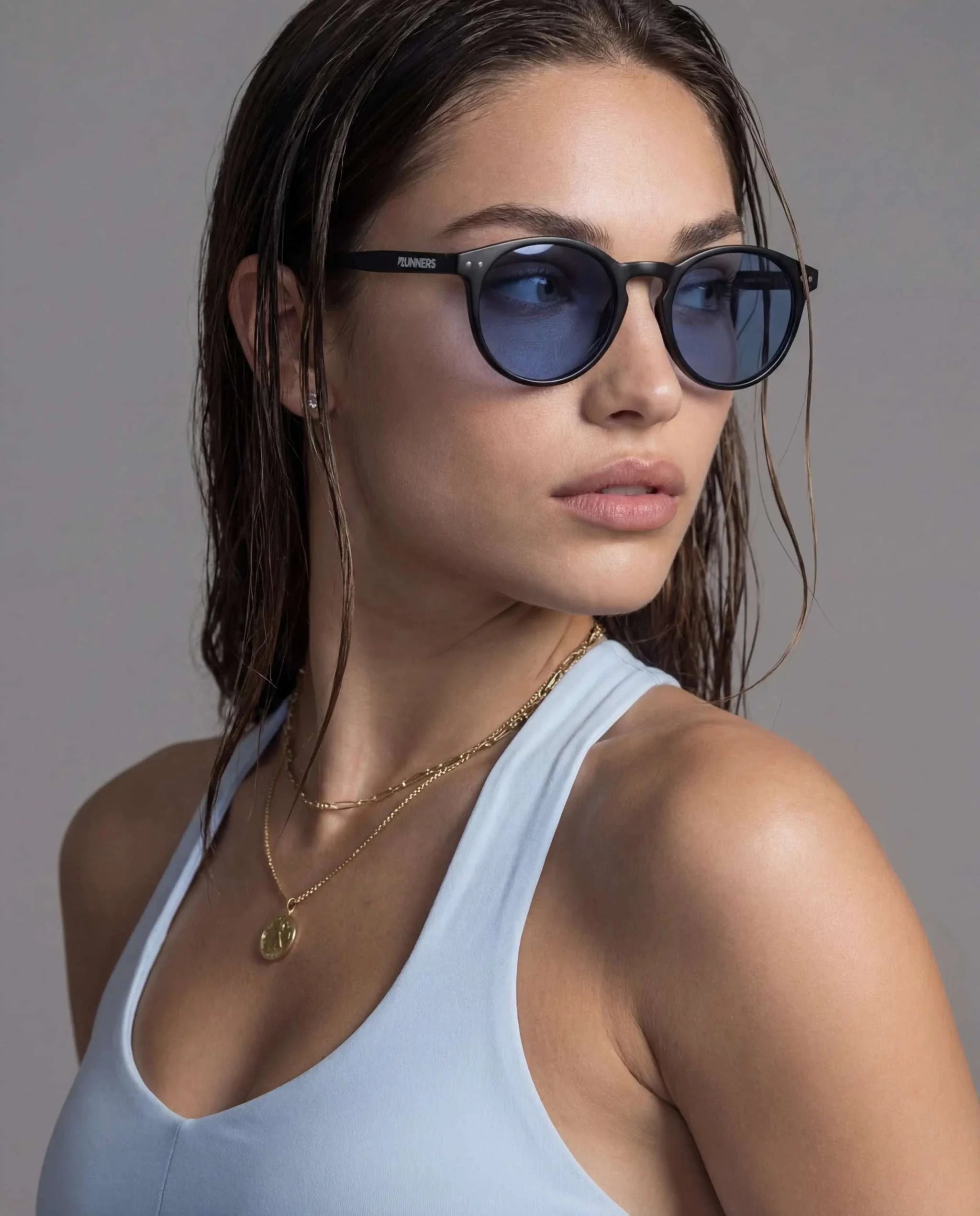 Black Round Polarized Sunglasses with a matte black frame and blue-tinted lenses in a rounded shape