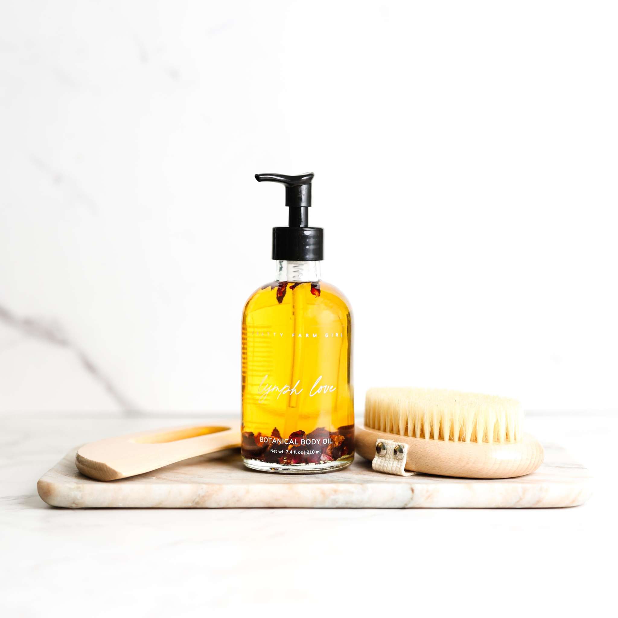 Body Care Lymphatic Routine Kit with amber botanical body oil, bamboo gua sha tool and dry brush set