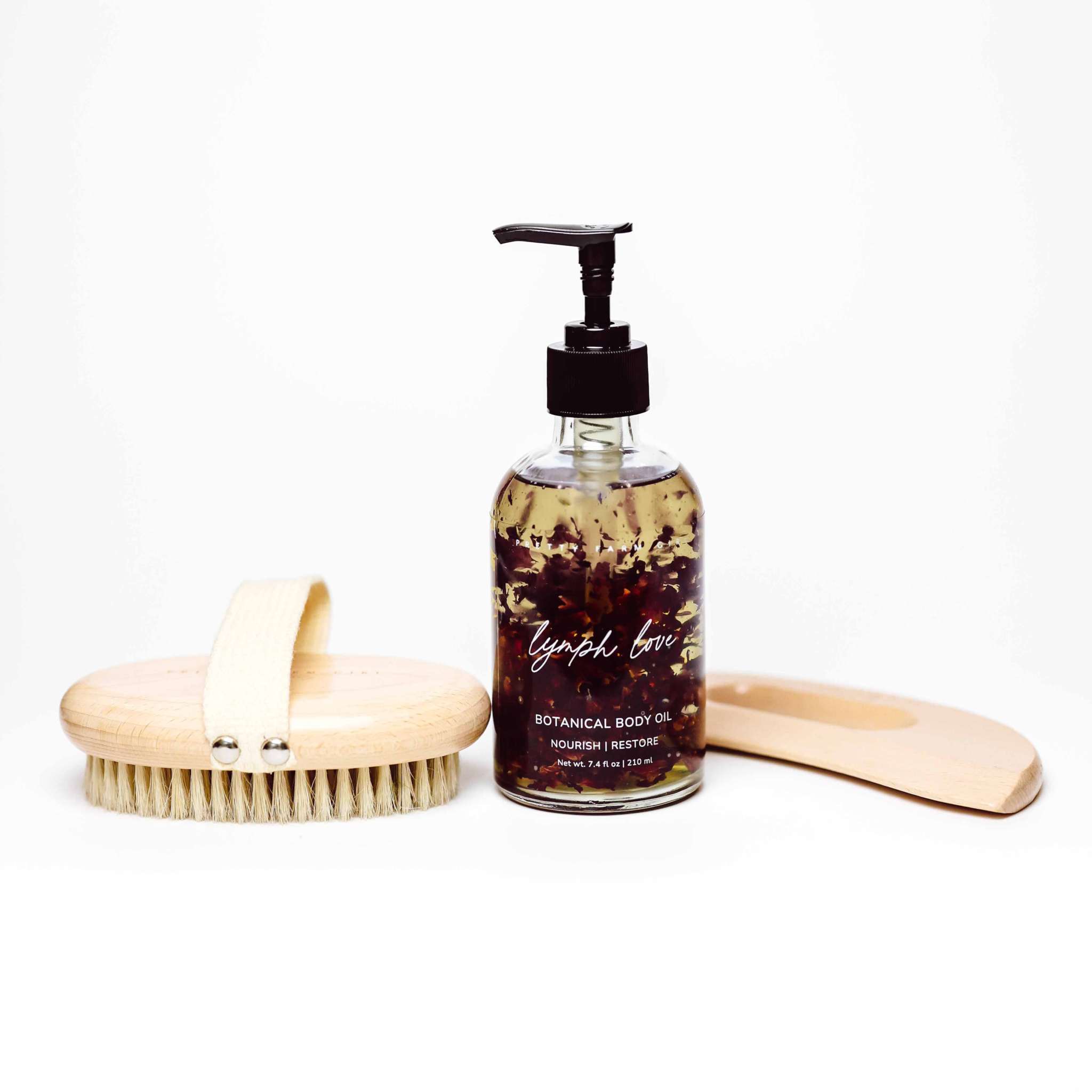 Body Care Lymphatic Routine Kit with amber botanical body oil, wooden dry brush, and bamboo gua sha tool