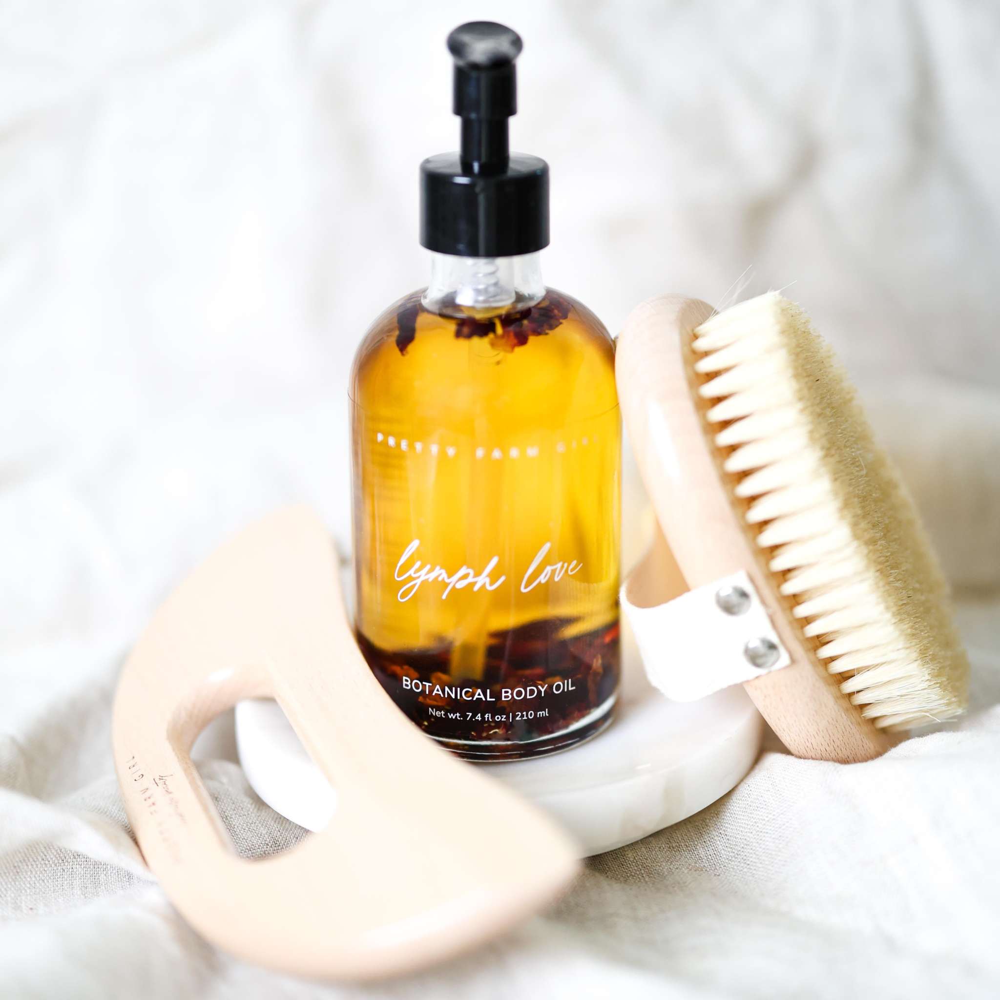 Body Care Lymphatic Routine Kit with amber botanical body oil, pale bamboo gua sha and sisal dry brush