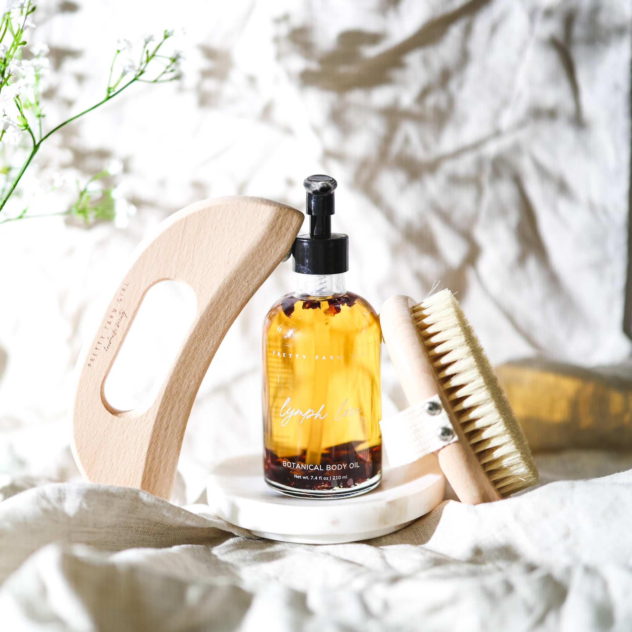 Body Care Lymphatic Routine Kit with amber botanical body oil, wooden gua sha tool and sisal dry brush set