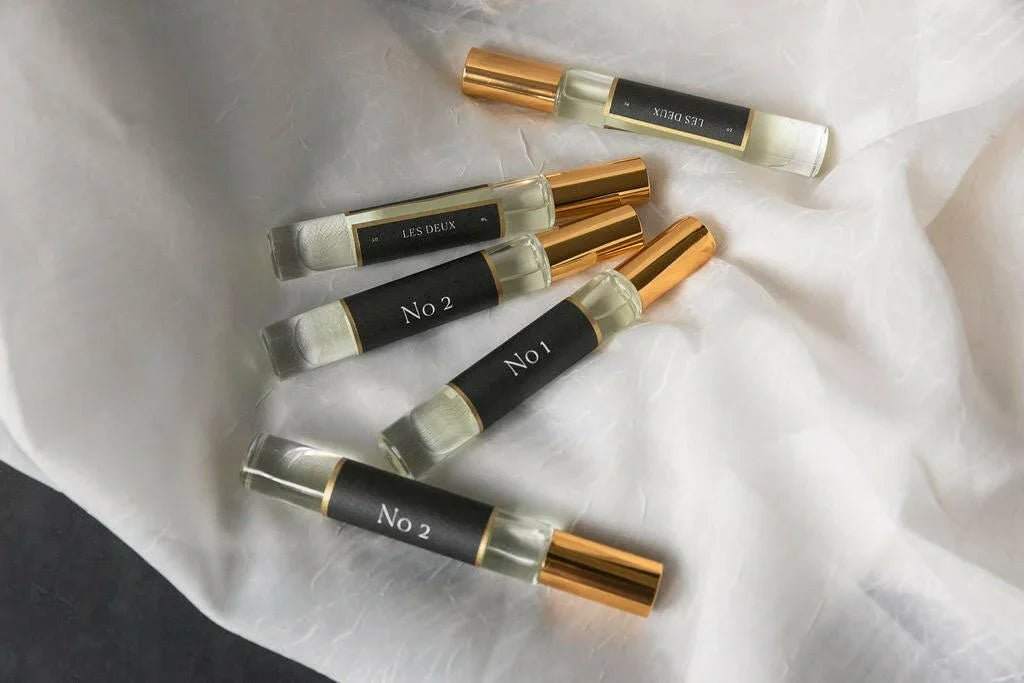 Bois Sacré Roll On Perfume Oil in a clear glass vial with black label and gold cap, 10ml rollerball perfume.