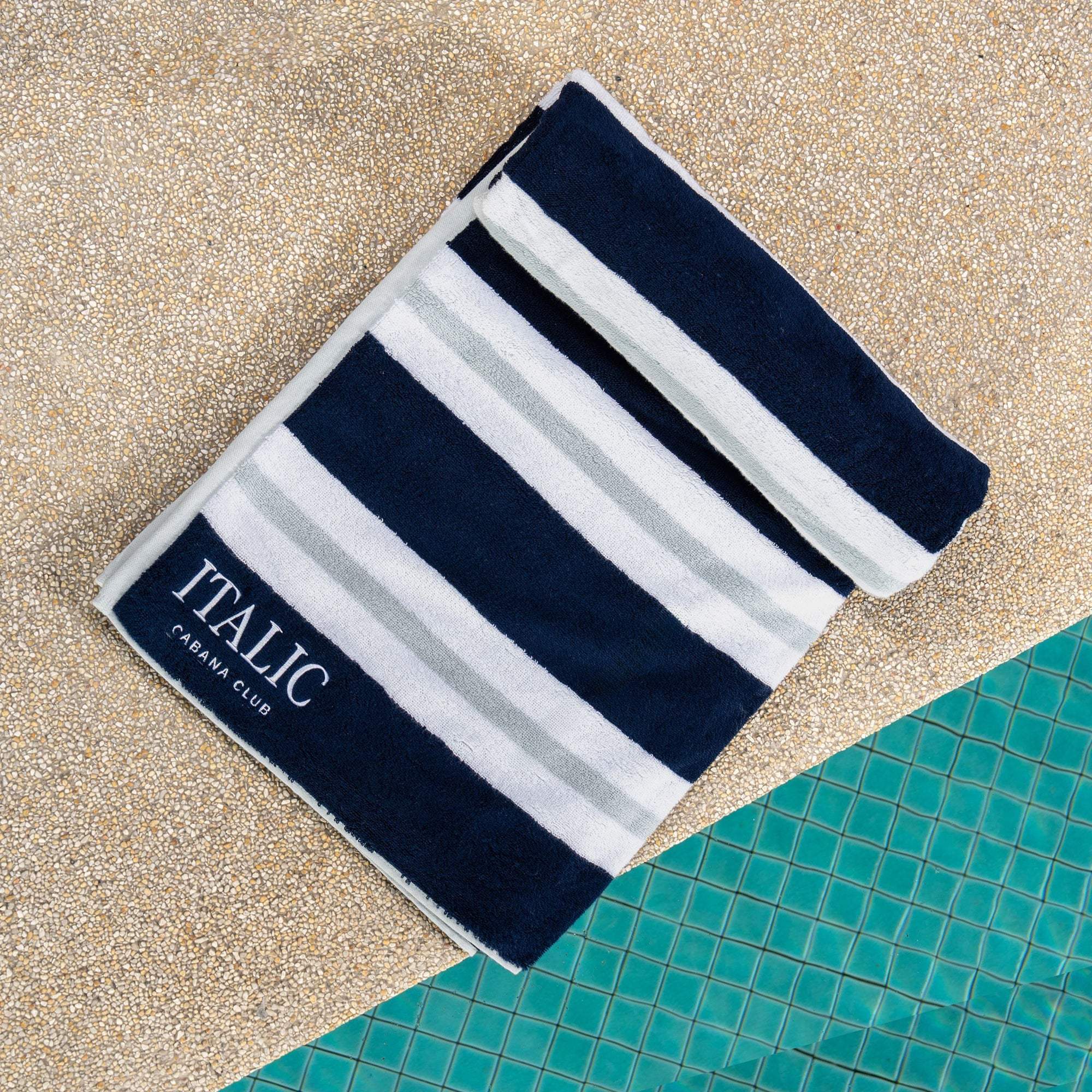 Beach towel in Bondi Australian Cotton, with bold navy, white and light gray stripes and a plush woven texture