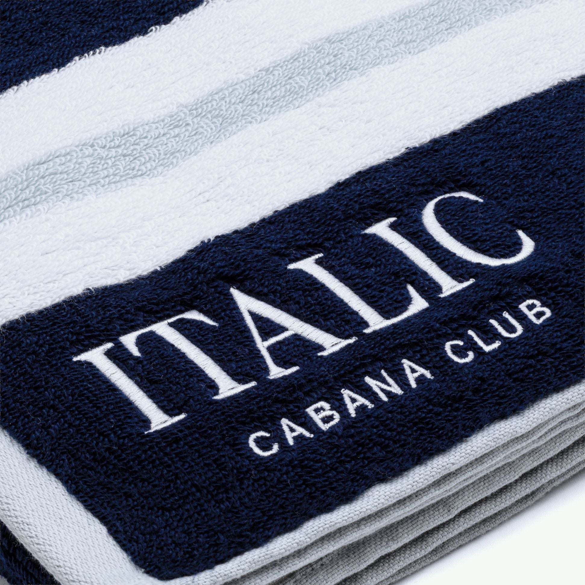 Bondi Australian Cotton beach towel in navy and white stripes, with a plush woven texture and Cabana Club lettering