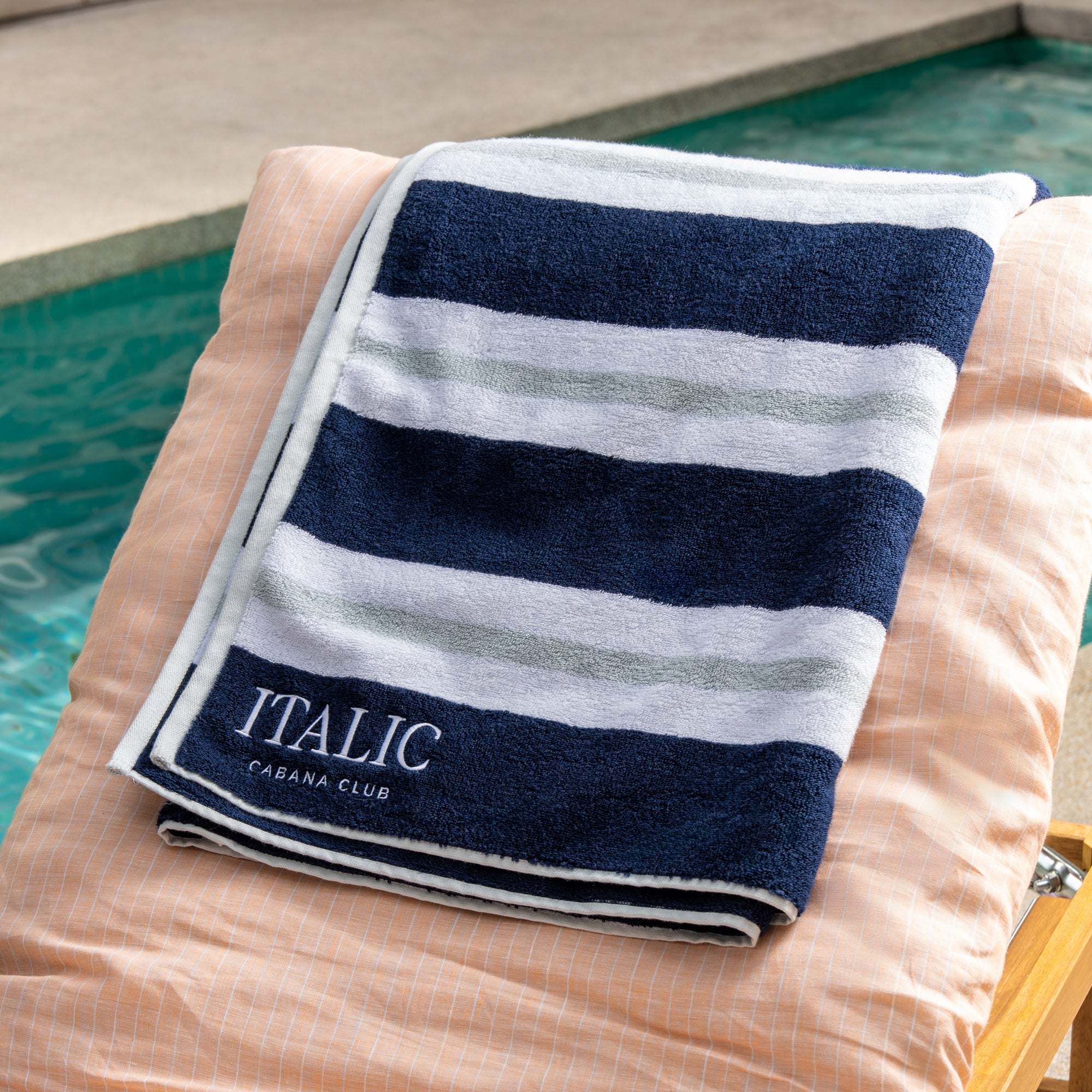 Bondi Australian Cotton beach towel with plush navy and white horizontal stripes and embroidered Cabana Club lettering