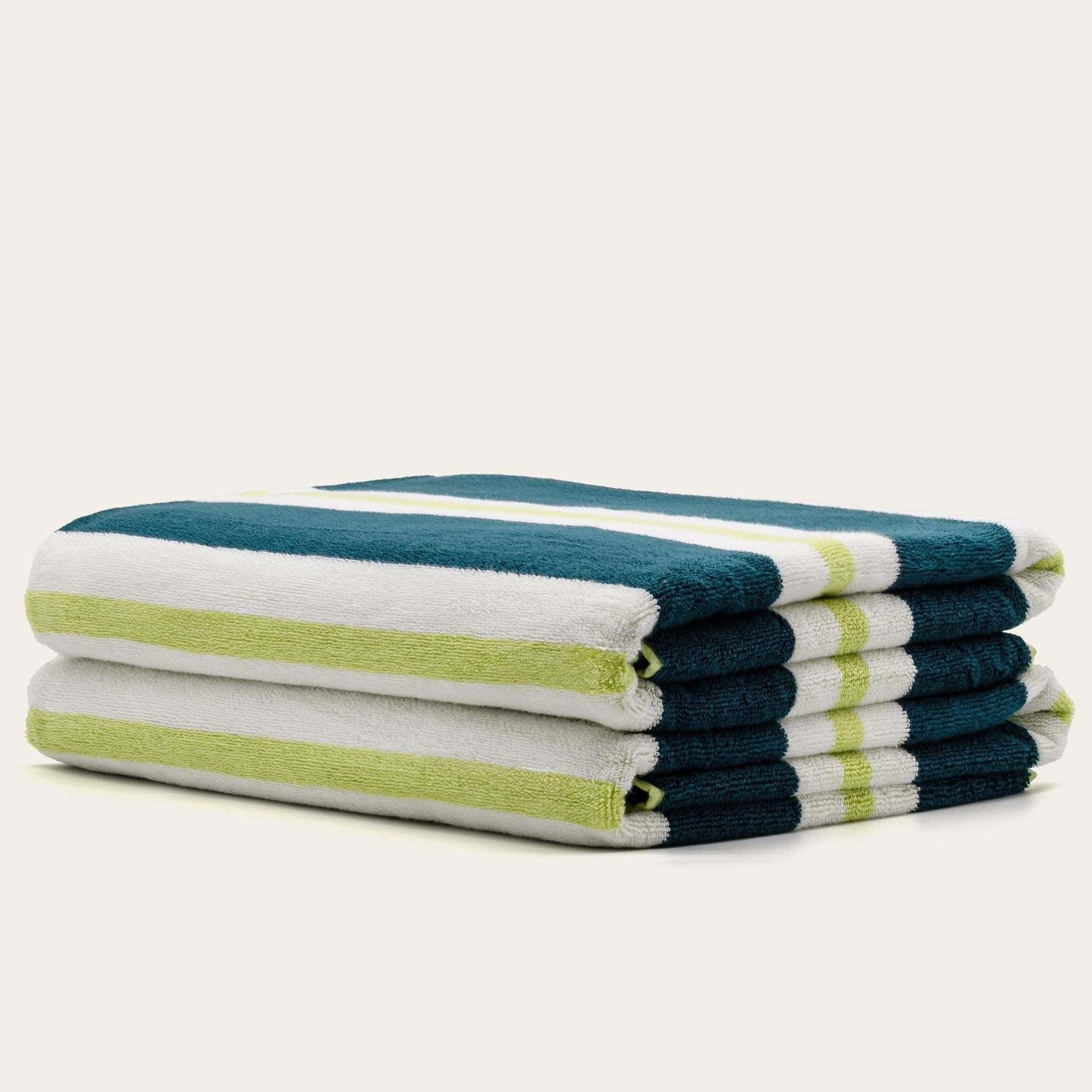 Bondi Australian Cotton beach towels in plush white terry with teal and lime green stripes, stacked in a set