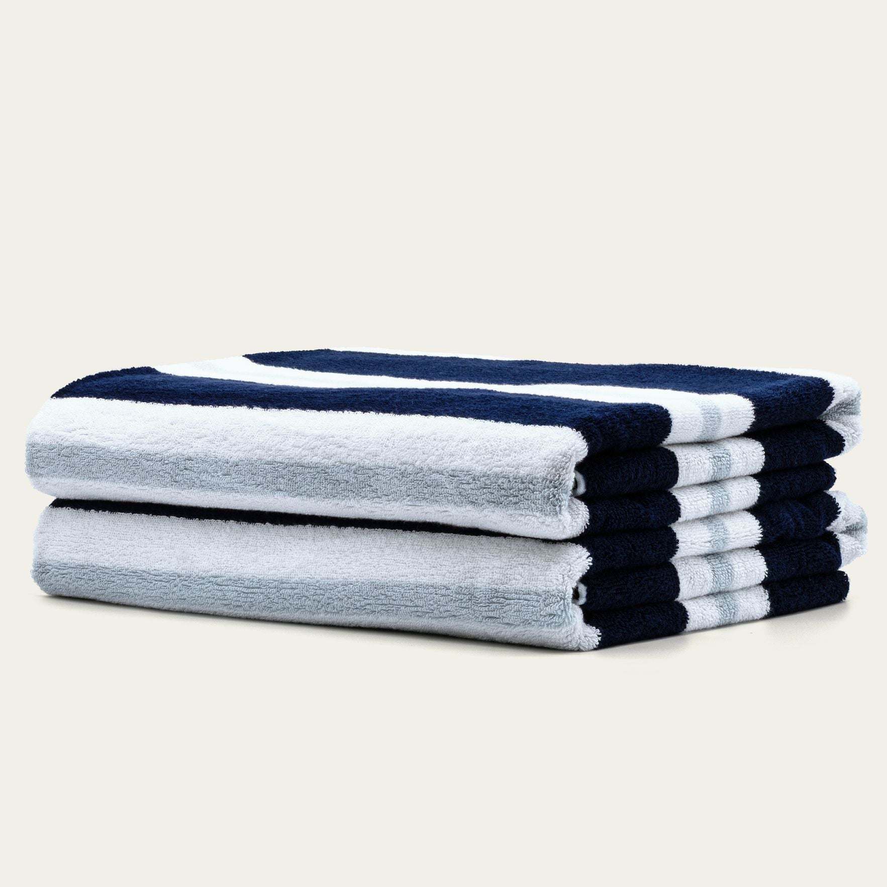 Bondi Australian Cotton beach towels in plush white and navy blue stripes, neatly folded with a thick textured pile