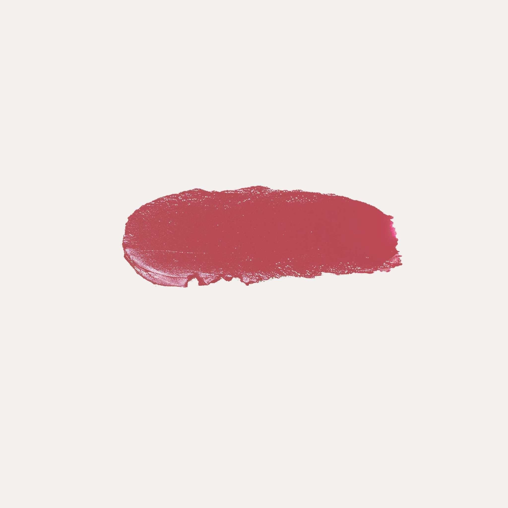 Buildable Cream Blush in a rich berry-red shade, shown as a creamy, softly textured swatch with a dewy finish