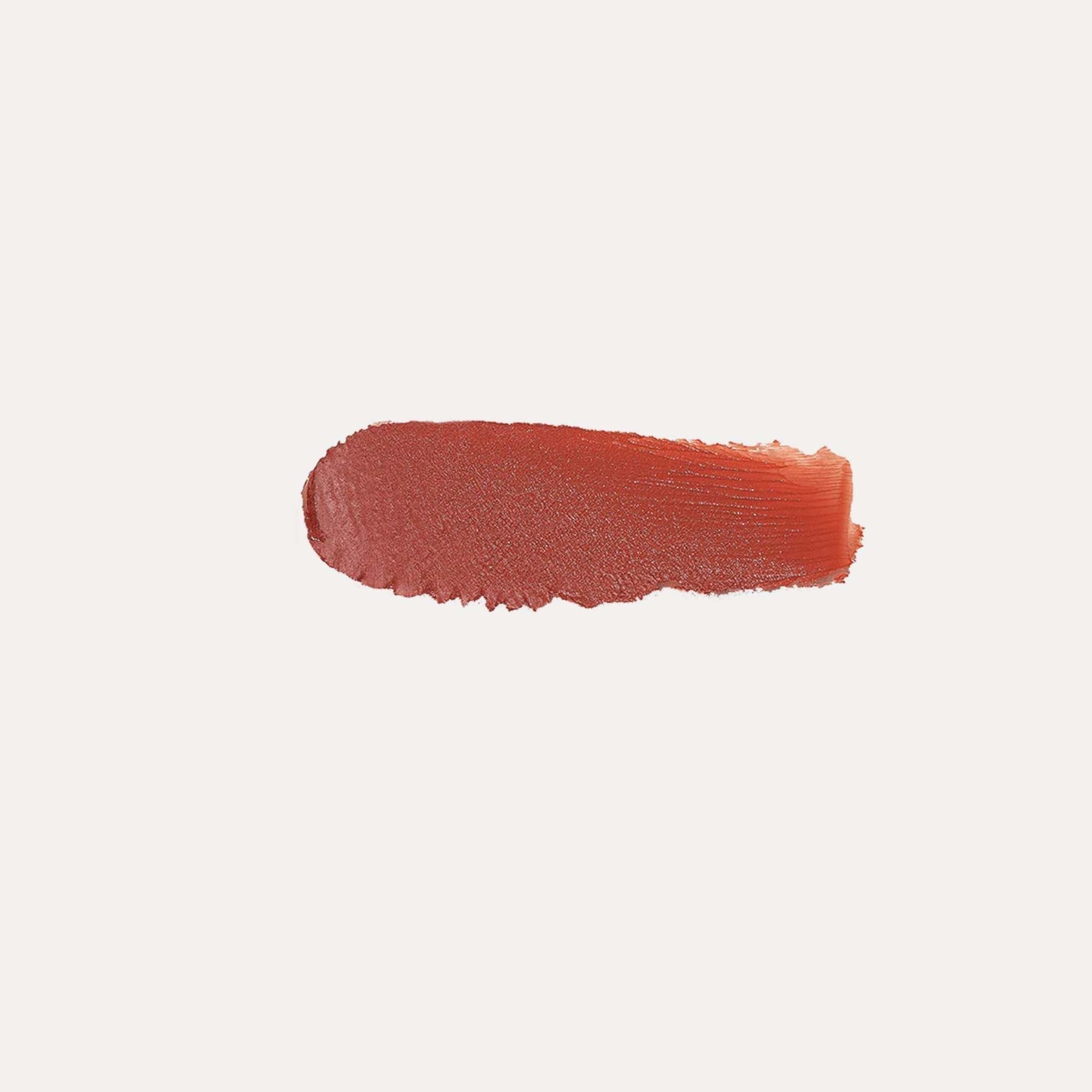 Buildable Cream Blush in a silky cream formula, shown as a warm terracotta-red swatch with a dewy finish