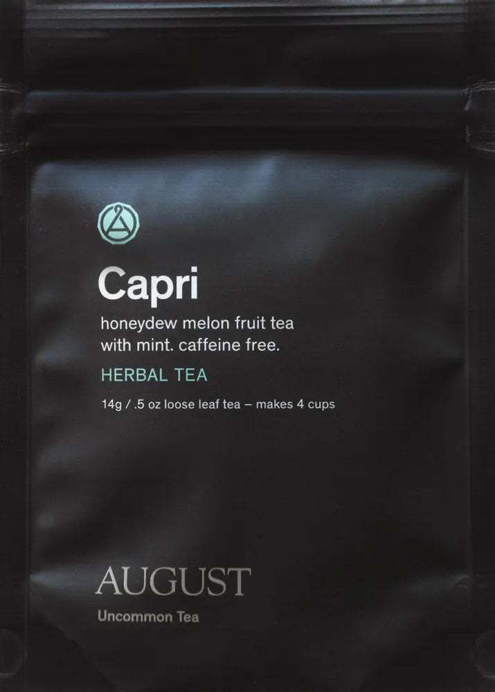 Capri - Honeydew Melon Mint Tea in a matte black loose-leaf tea pouch, labeled caffeine-free herbal tea