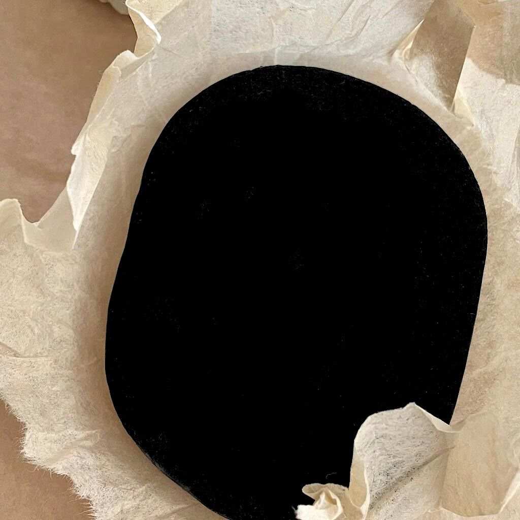 Charcoal Infused Face Sponge, black soft-textured cleansing sponge with a rounded rectangular shape