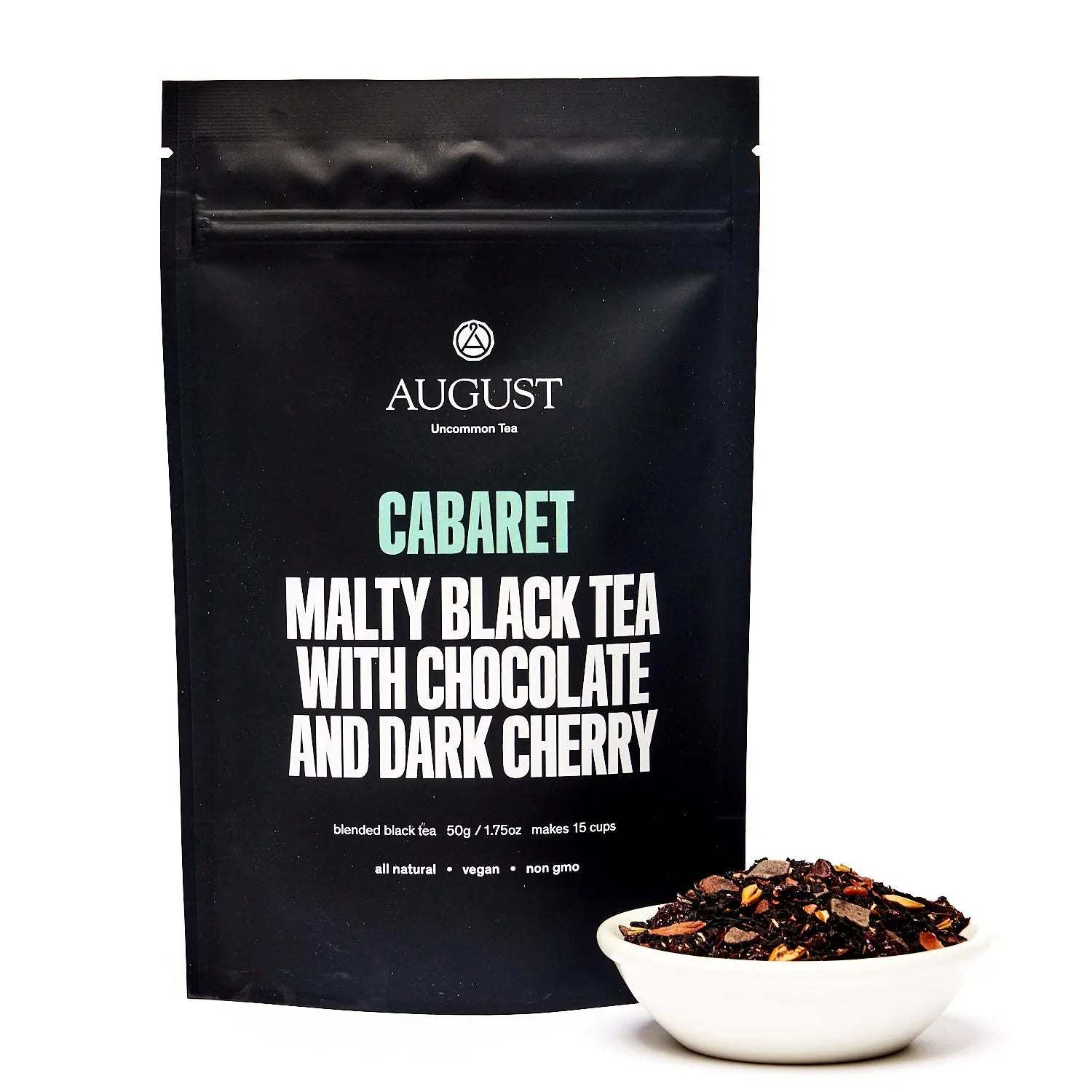 Cherry Chocolate Black Tea in a black August pouch, with loose dark tea leaves and visible cherry pieces in a white bowl