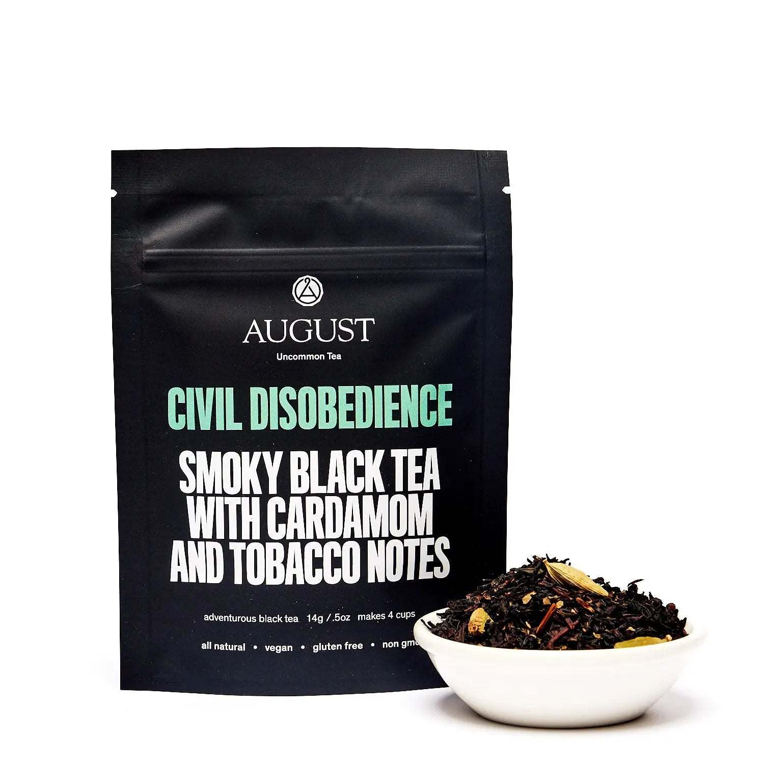 Civil Disobedience black tea in a matte black pouch with turquoise lettering, shown with loose dark tea leaves and spices