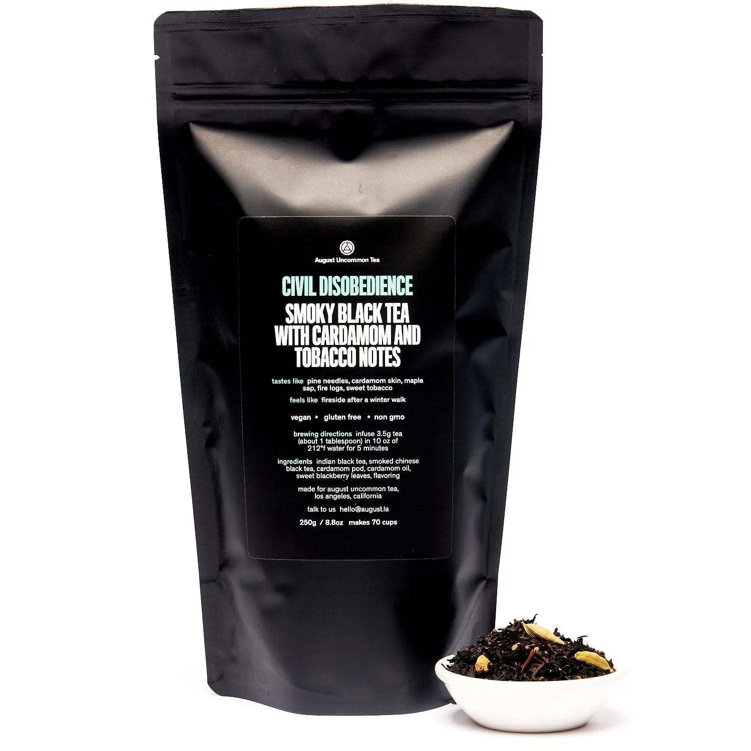 Civil Disobedience smoky black tea in a matte black resealable pouch, with loose tea leaves in a white bowl